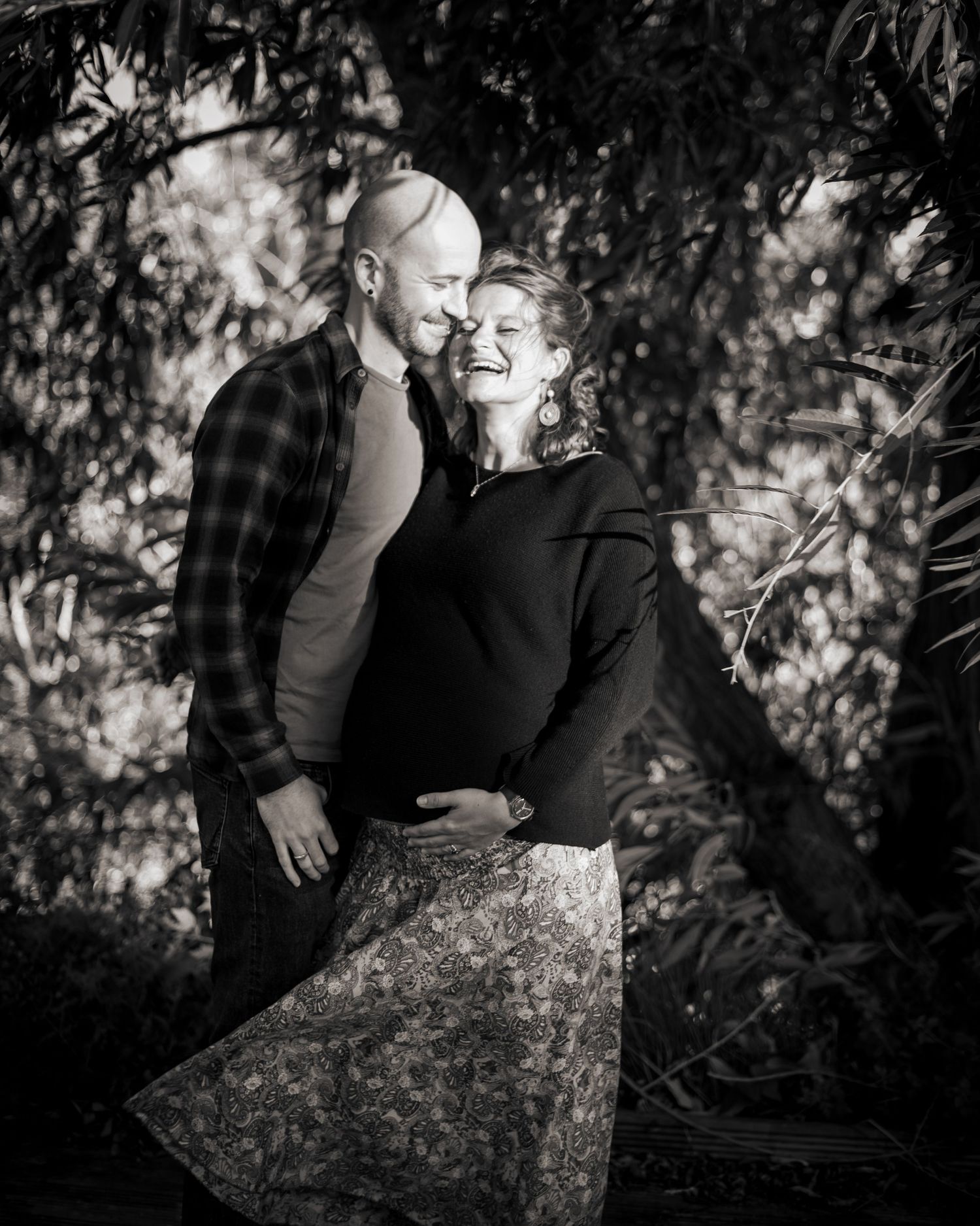 A romantic black and white photo of a couple during an outdoor pregnancy shoot in Leeds.