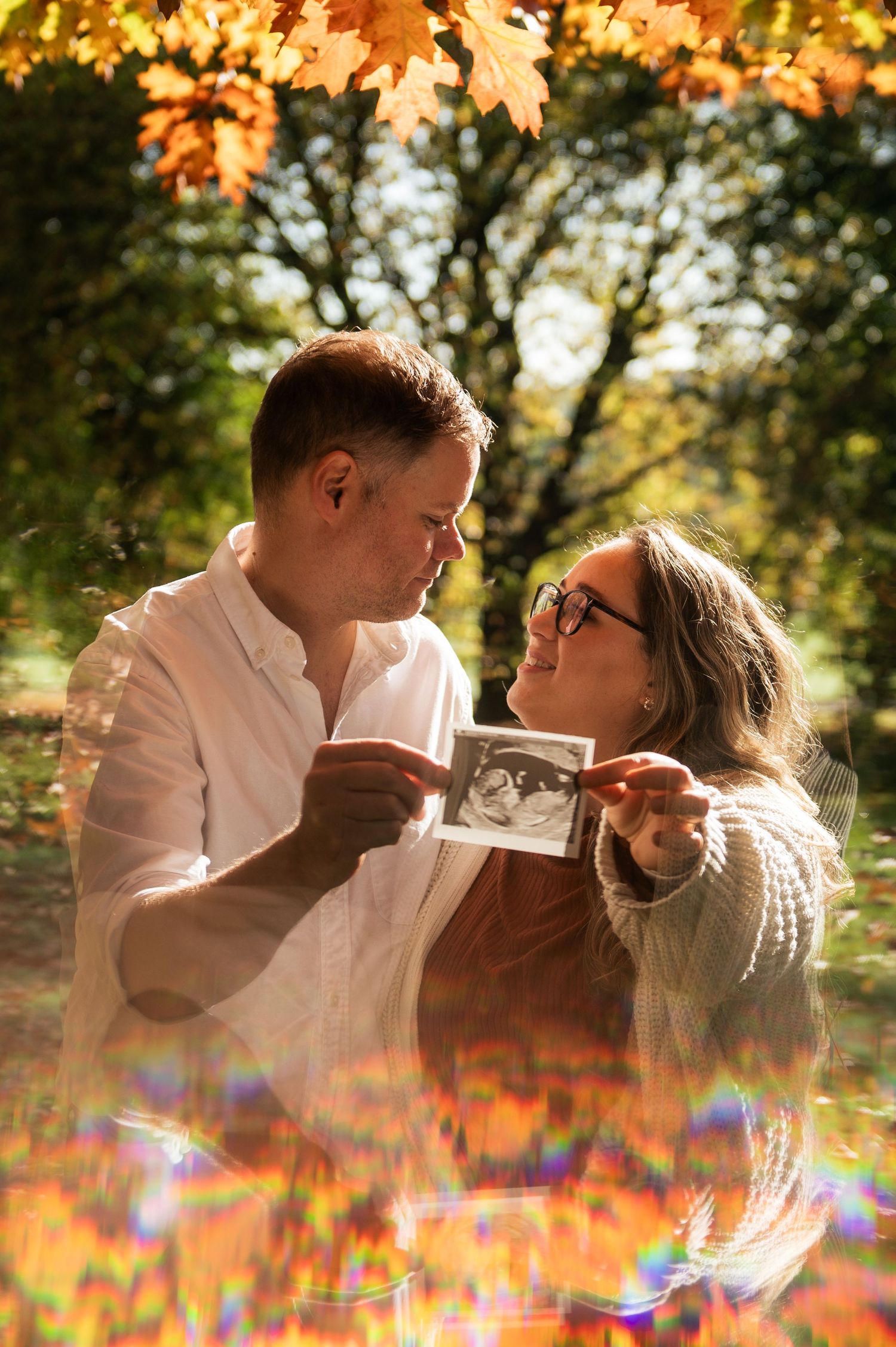 Artistic autumnal portrait of a couple announcing their pregnancy during a maternity shoot in Leeds.