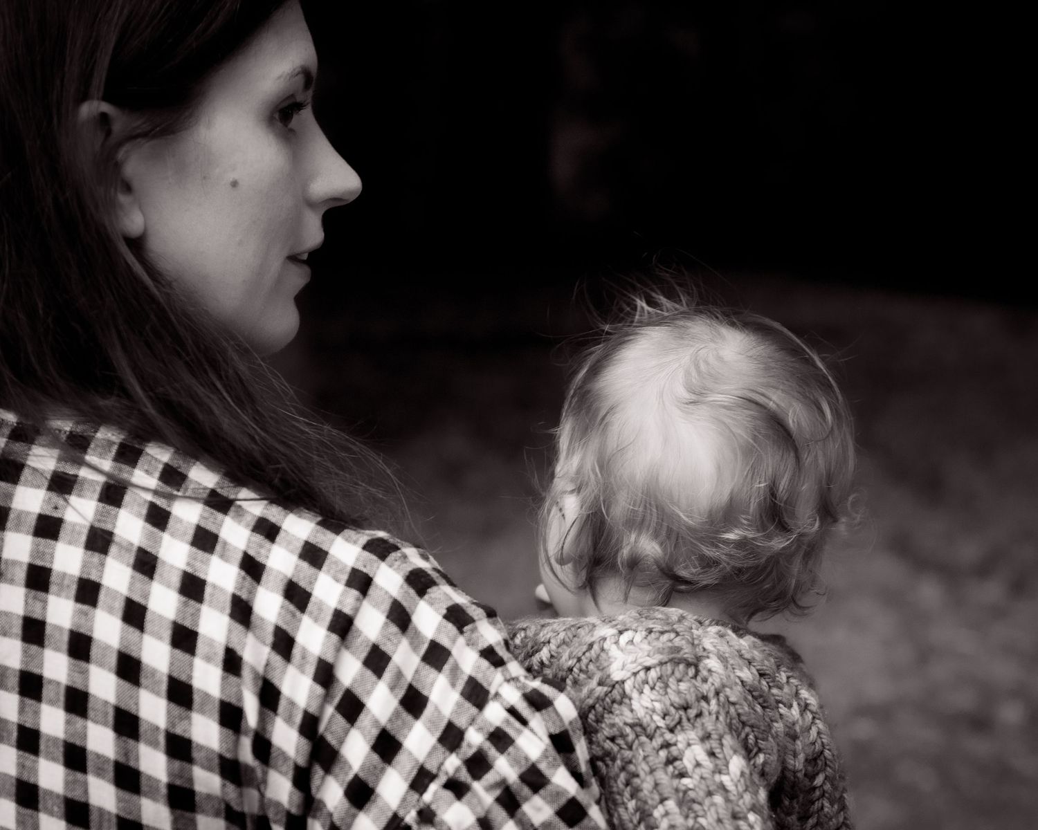 Black and white close-up portrait showing a tender mother-daughter moment during a family photoshoot in Leeds.