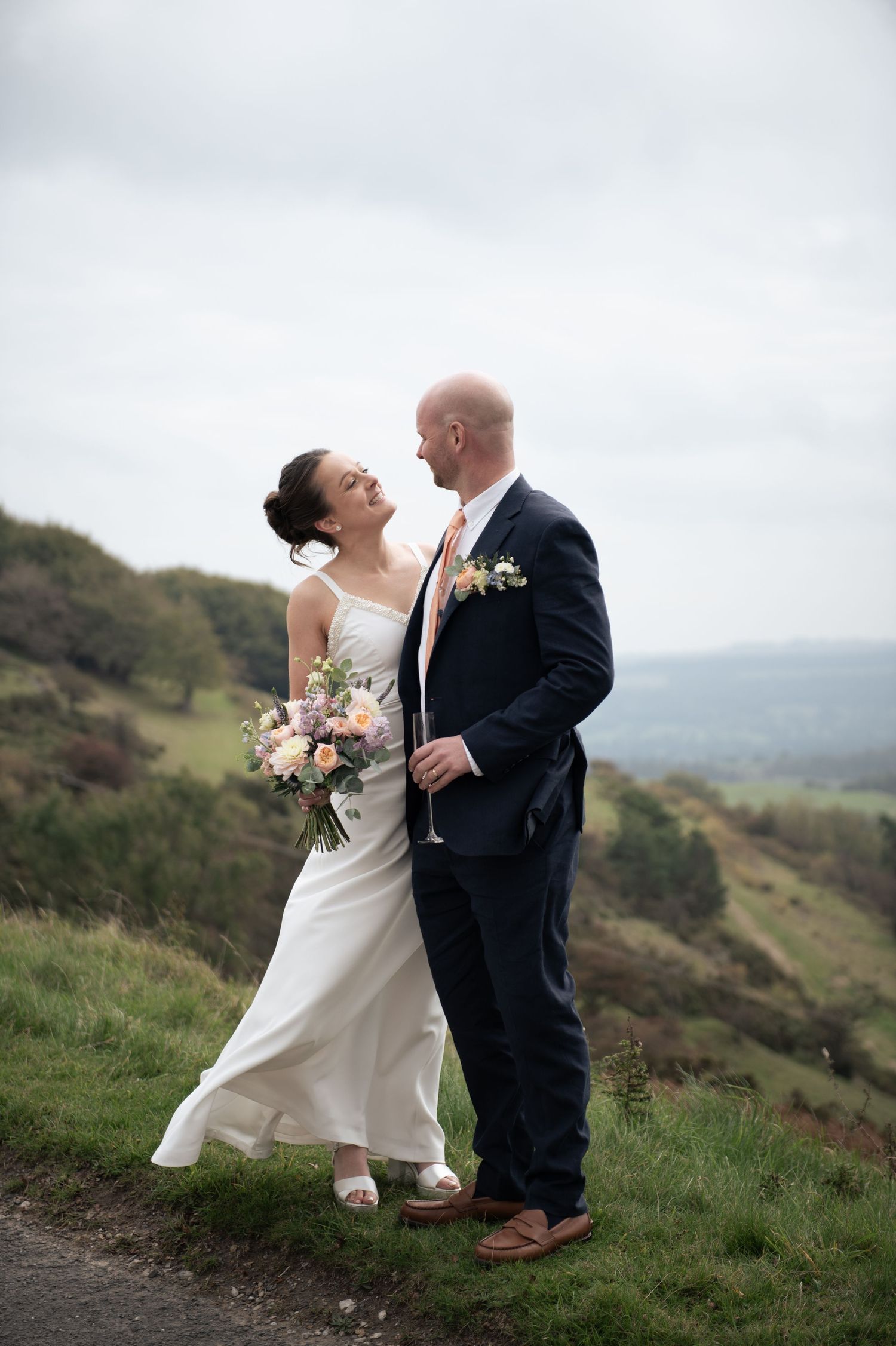 Romantic wedding portrait on Longley Edge, Buxton, with rolling landscape in background.