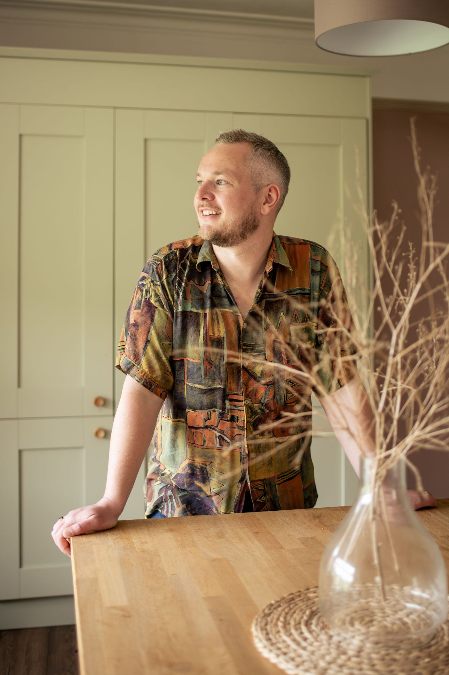 Relaxed business headshots of a Yorkshire-based interior designer with a glass decanter.