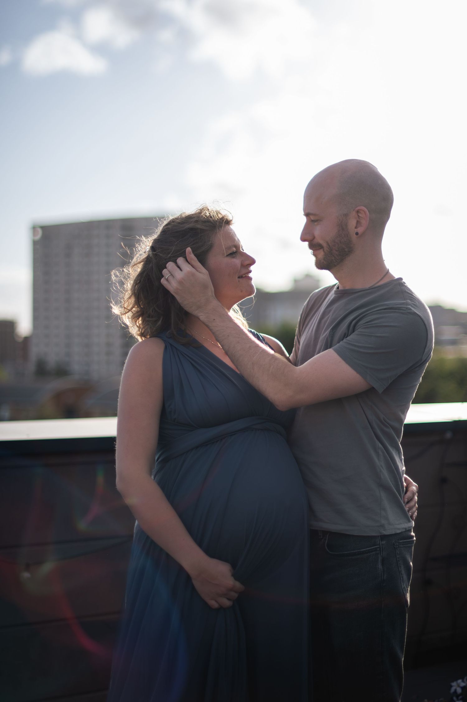 A rooftop portrait of a couple during a pregnancy session in Leeds.