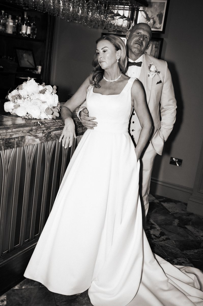 Modern black and white photo of the happy couple in the bar at their wedding reception at Wentbridge House Hotel, Pontefract.