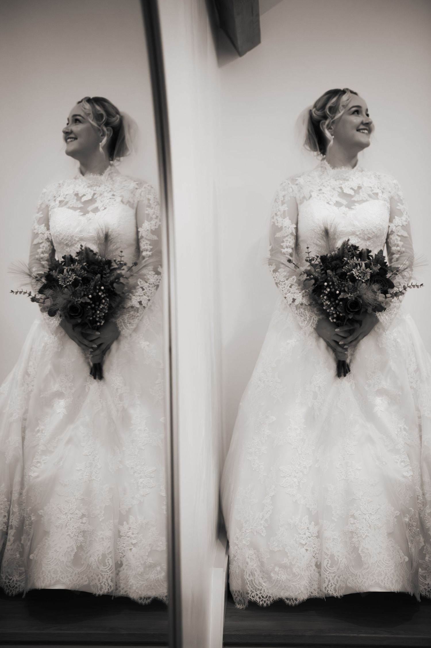 Mirror reflection of an LGBT bride in a lace wedding gown holding a bouquet in the bridal suite at Lodge Farm Weddings, Yorkshire.