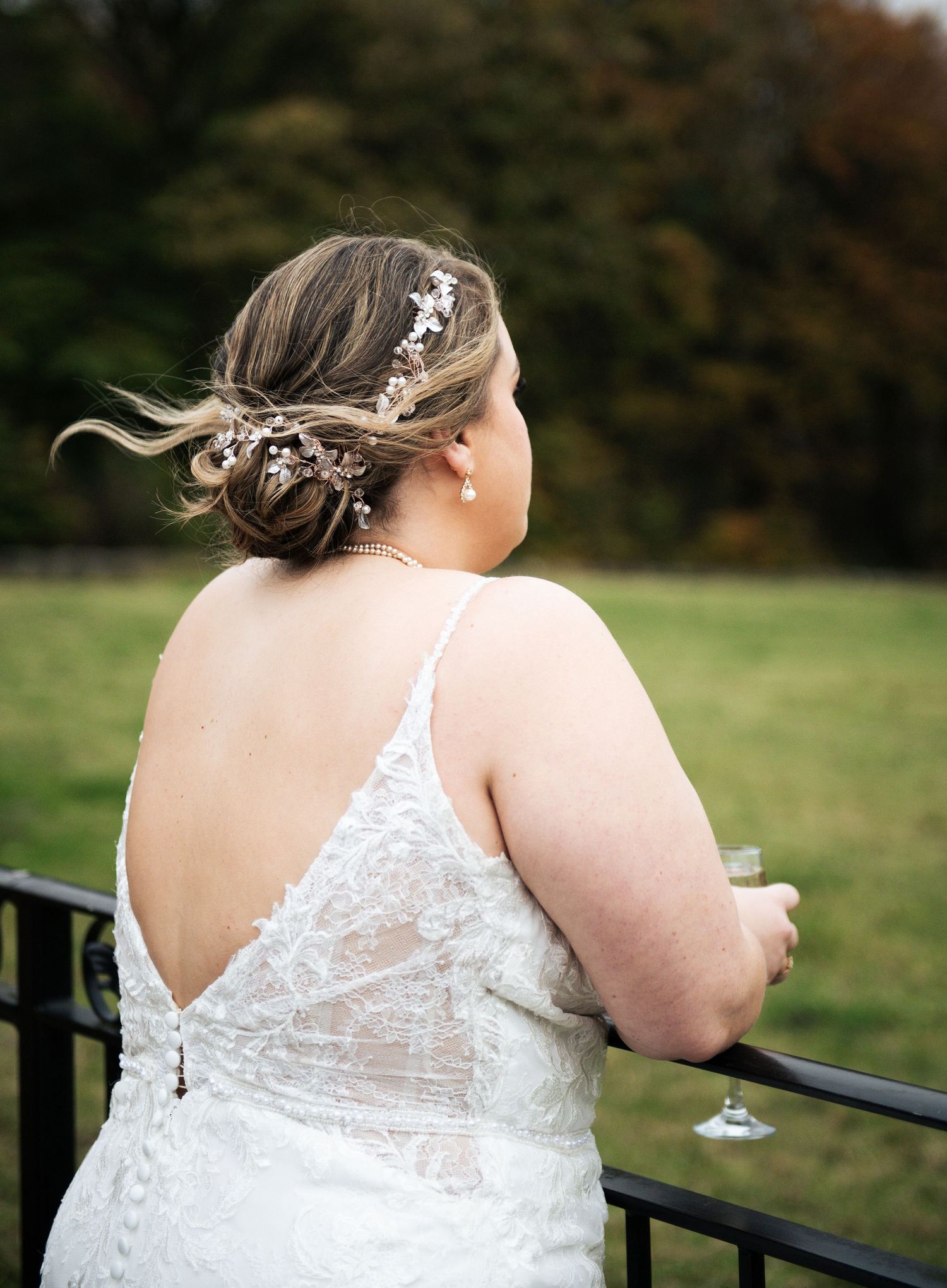 Back view of a bride in lace dress details standing on an outdoor terrace, at The Fleece Inn, Halifax