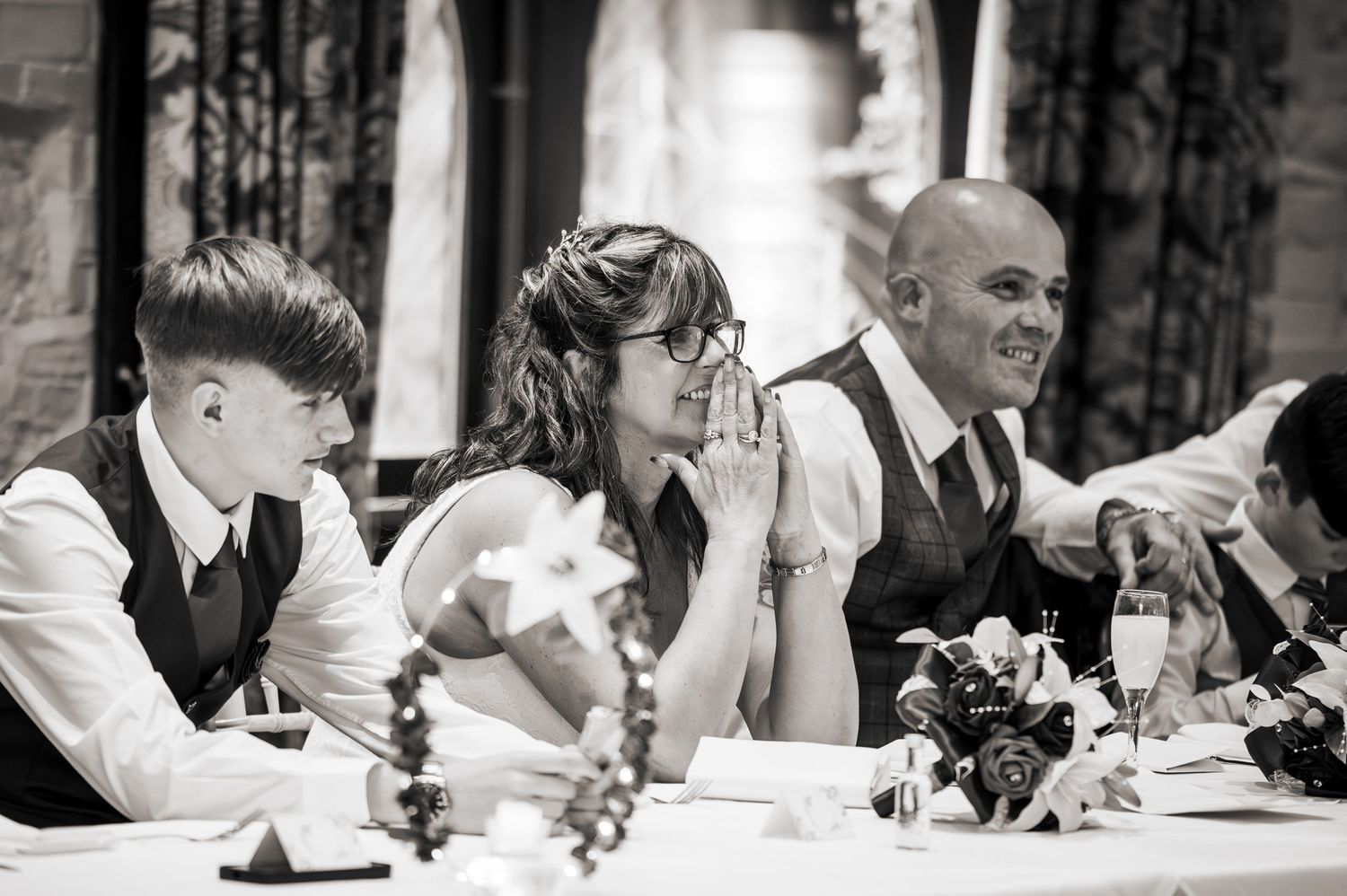 A bride tries not to cry during the speeches at her wedding at Holdsworth House, Halifax.