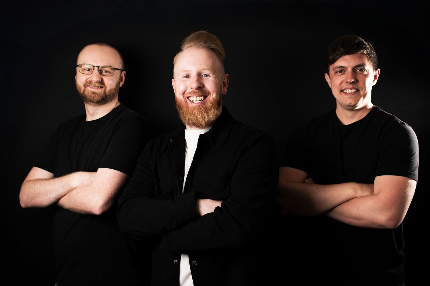 Studio headshots on black background showcase professional team members in dark clothing, in Leeds.