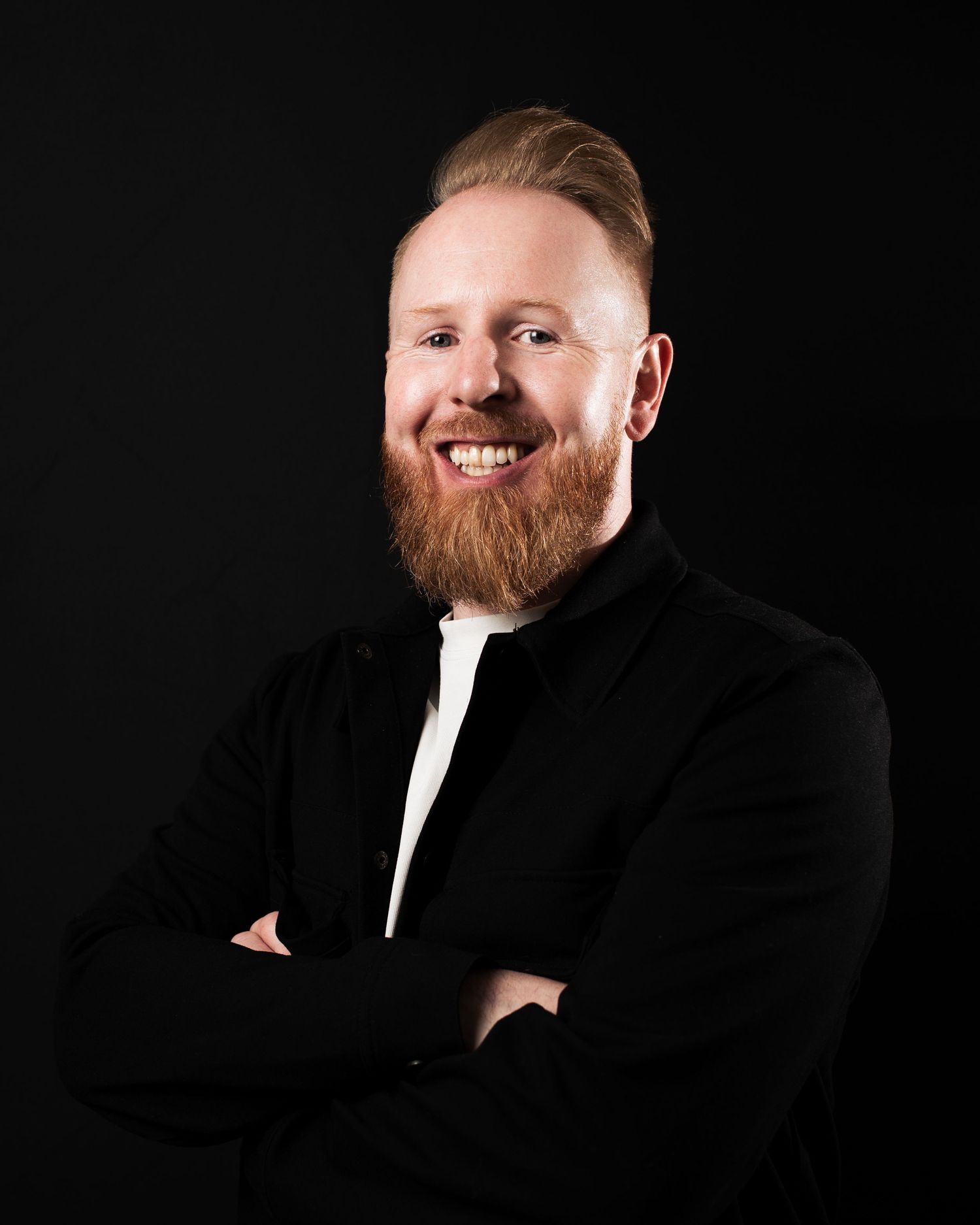 Professional headshots against black background showing warm expressions and formal attire, in Leeds.
