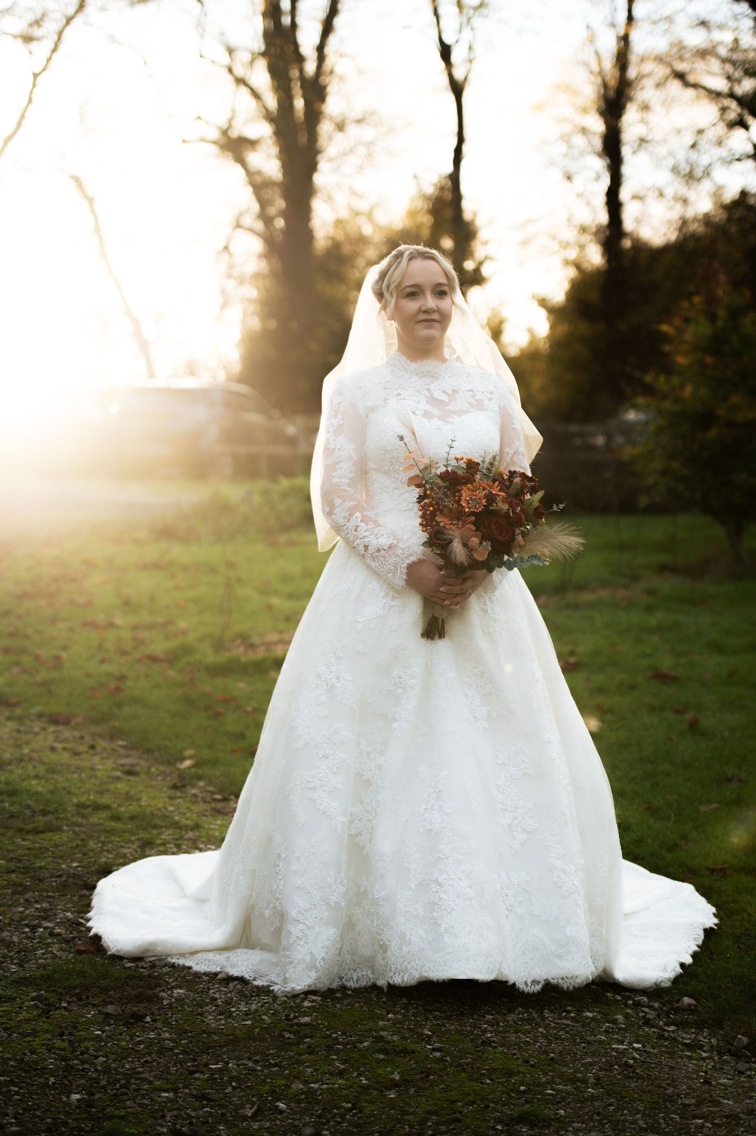 White wedding dress detail shot with autumn bouquet in natural outdoor setting, at Lodge Farm Weddings, Yorkshire.