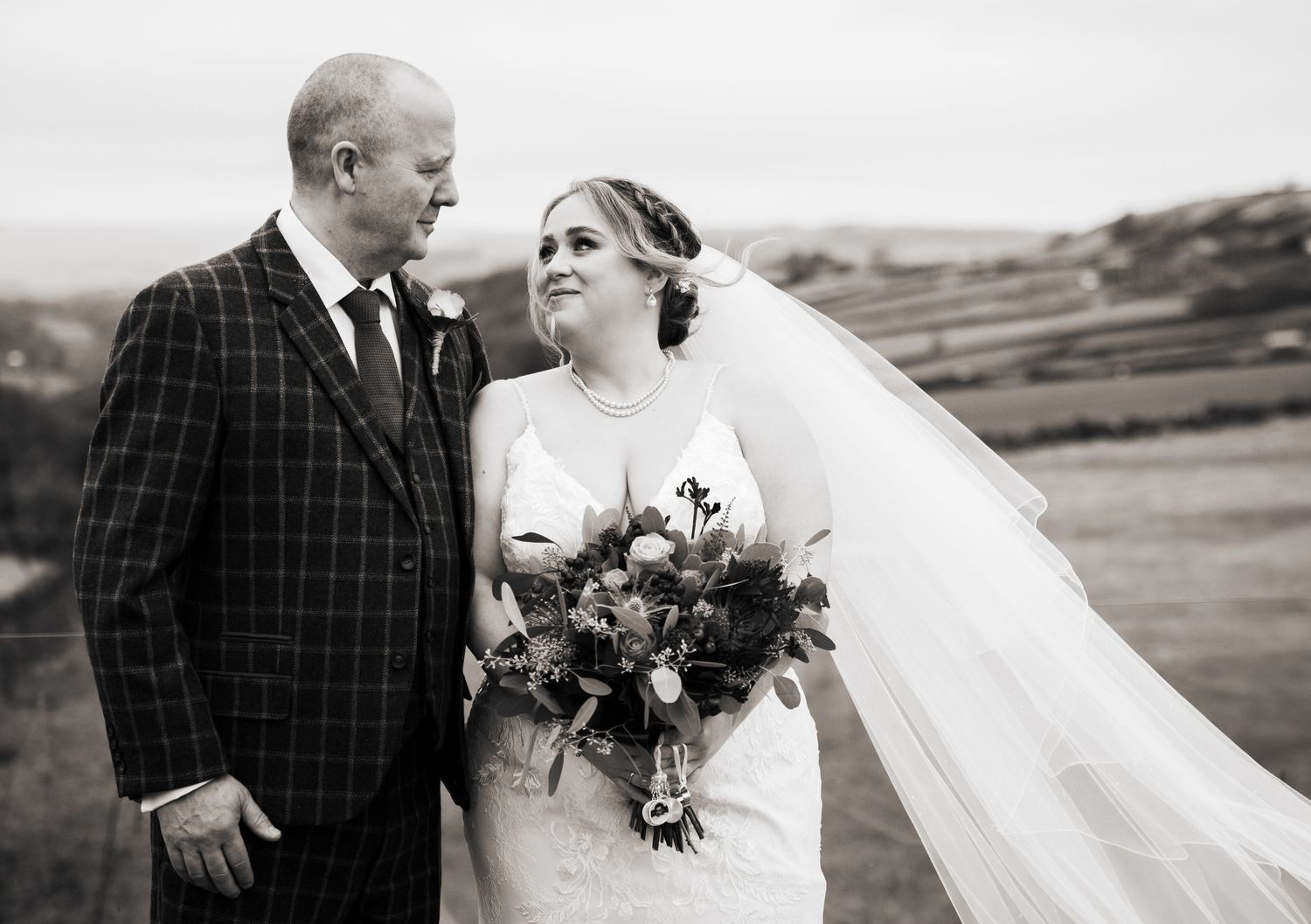 Black and white wedding photos showing a bride and father of the bride-style shot, at The Fleece Inn, Halifax.