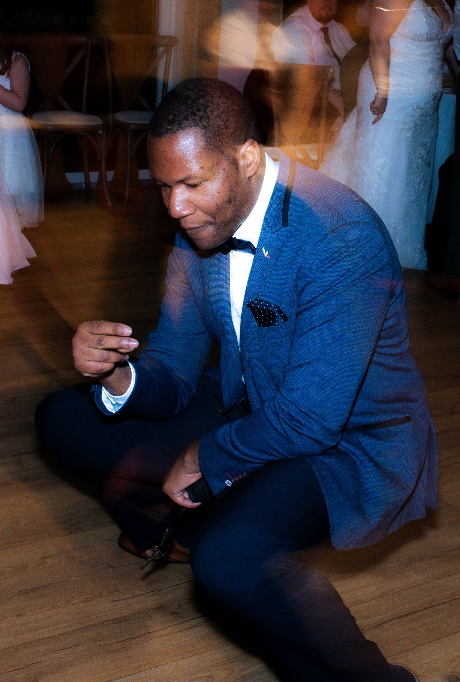 People in formal attire dancing and moving on a wooden dance floor at a wedding at The Fleece Inn, Halifax.