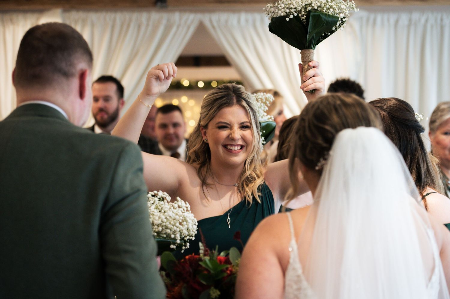 Indoor wedding ceremony with elegant white draping and floral decorations, at The Fleece Inn, Halifax.