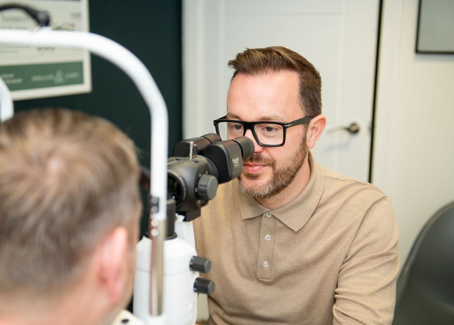 Eye doctor using optometry equipment during patient examination - business photos in Brigg, North Lincolnshire.