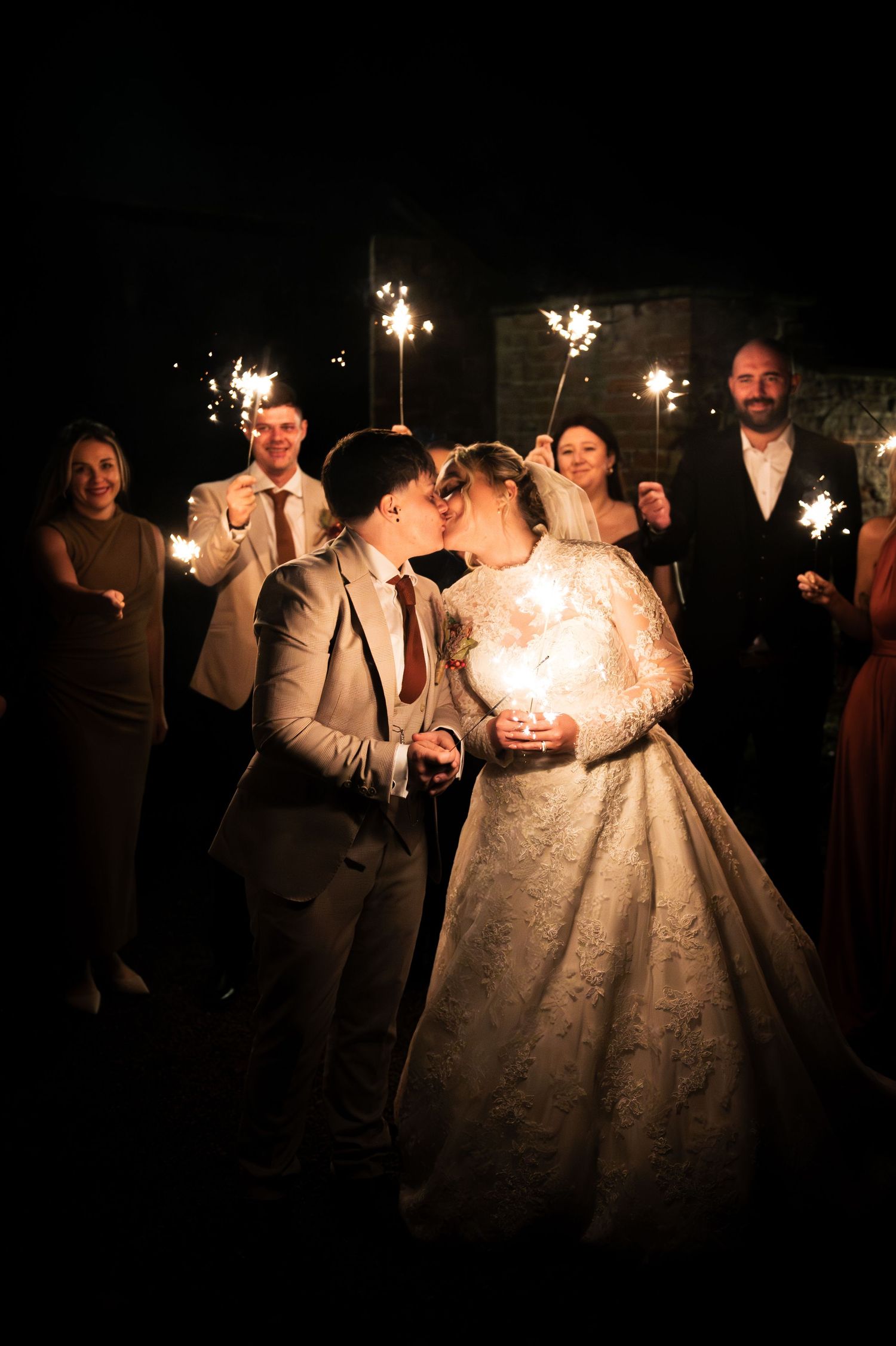 Nighttime sparkler celebration with wedding couple surrounded by guests at Lodge Farm Weddings, Yorkshire.