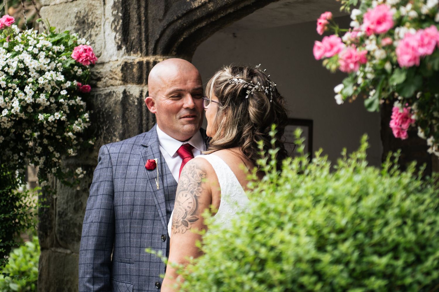 A bride and groom share a quiet documentary-style moment during their wedding at Holdsworth House, Yorkshire.