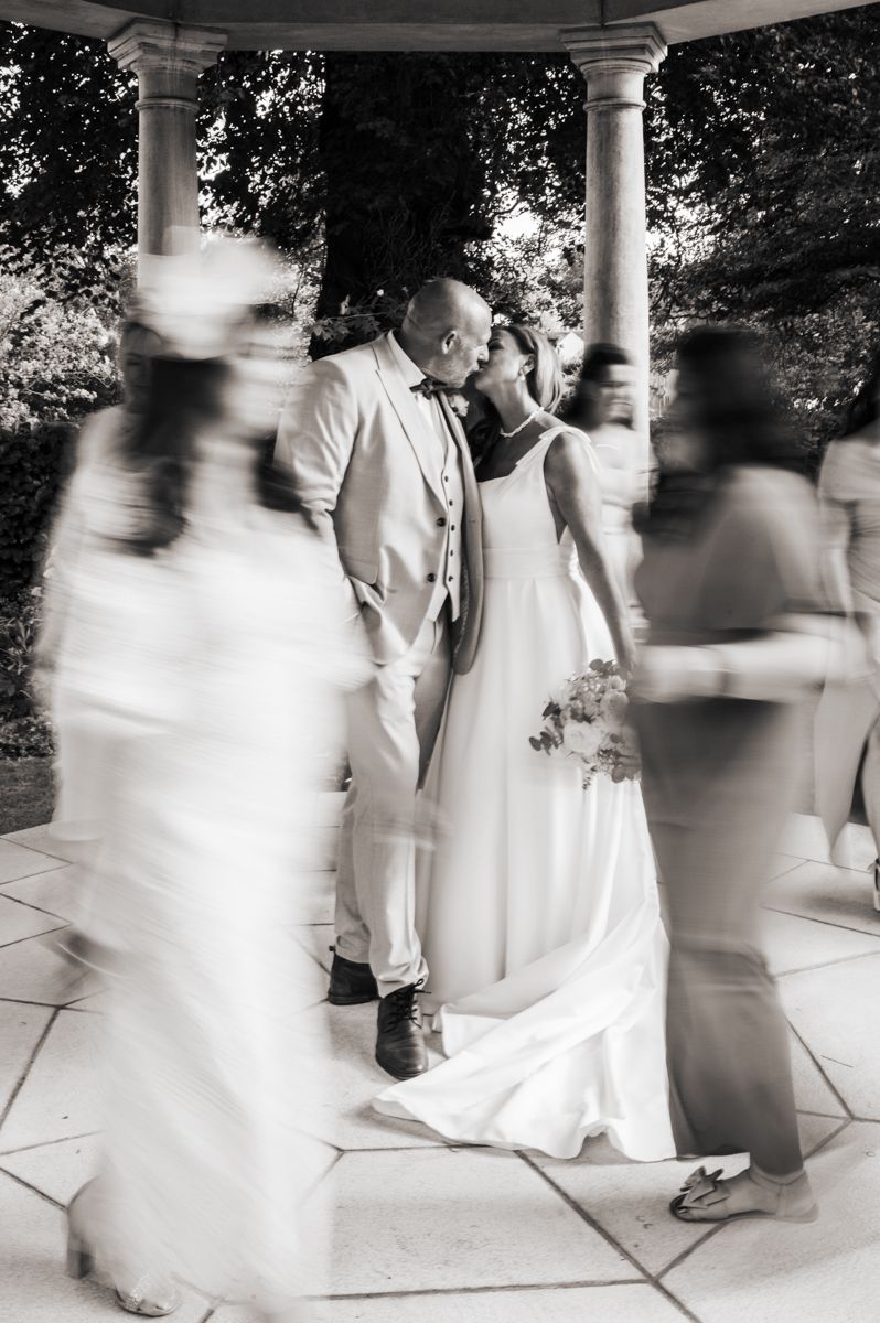 Artistic modern motion-blurred black and white wedding kiss under a gazebo at Wentbridge House Hotel, Pontefract.