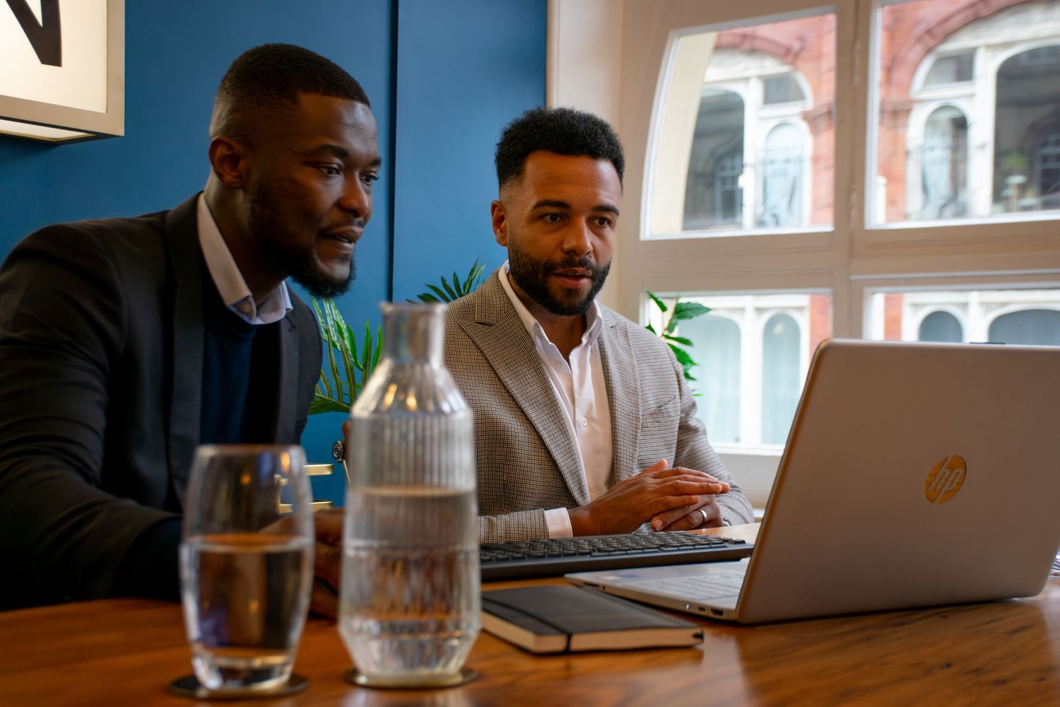 Professional working at a laptop in a modern office setting with natural lighting, a relaxed shot for a Leeds marketing business