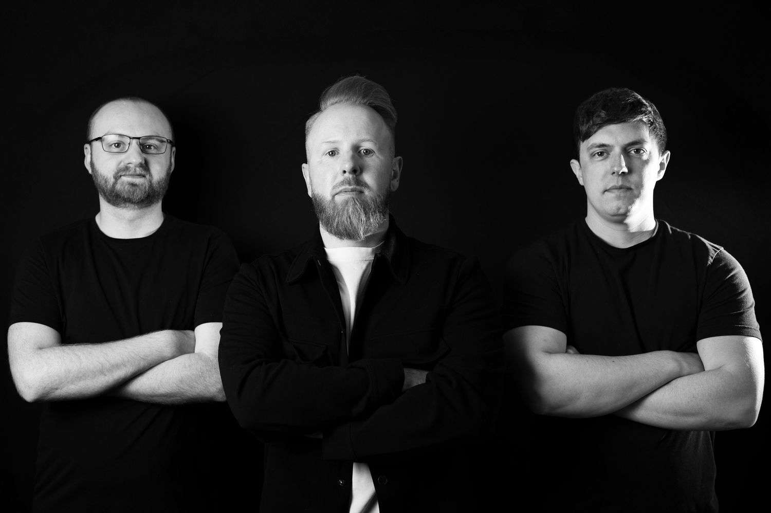 Black and white studio headshots showing dramatic side lighting on dark background, in Leeds.