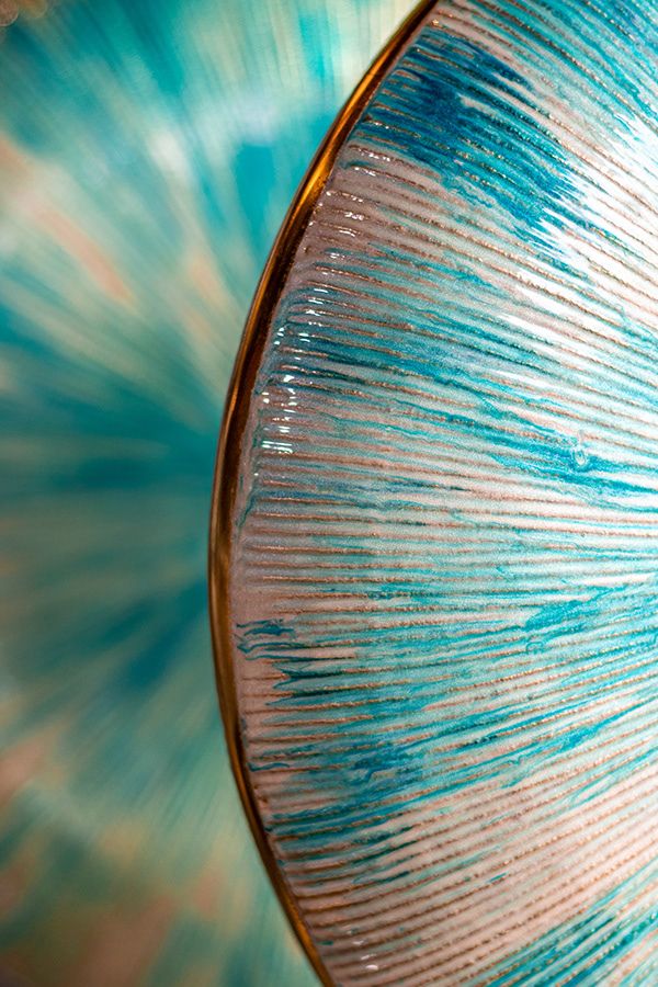 Abstract macro photography of turquoise and white textured surface with radial pattern.