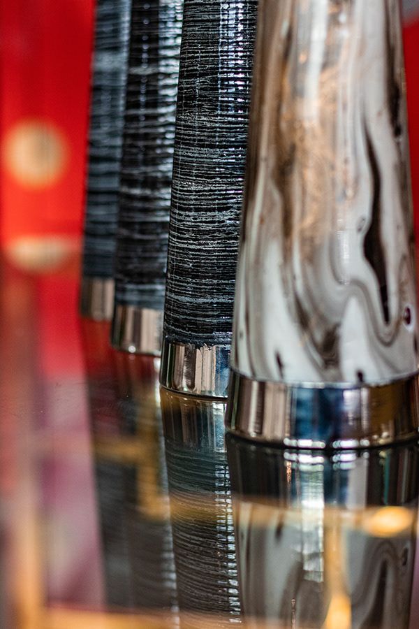 Close-up of textured black fabric materials with metallic accents in retail display.