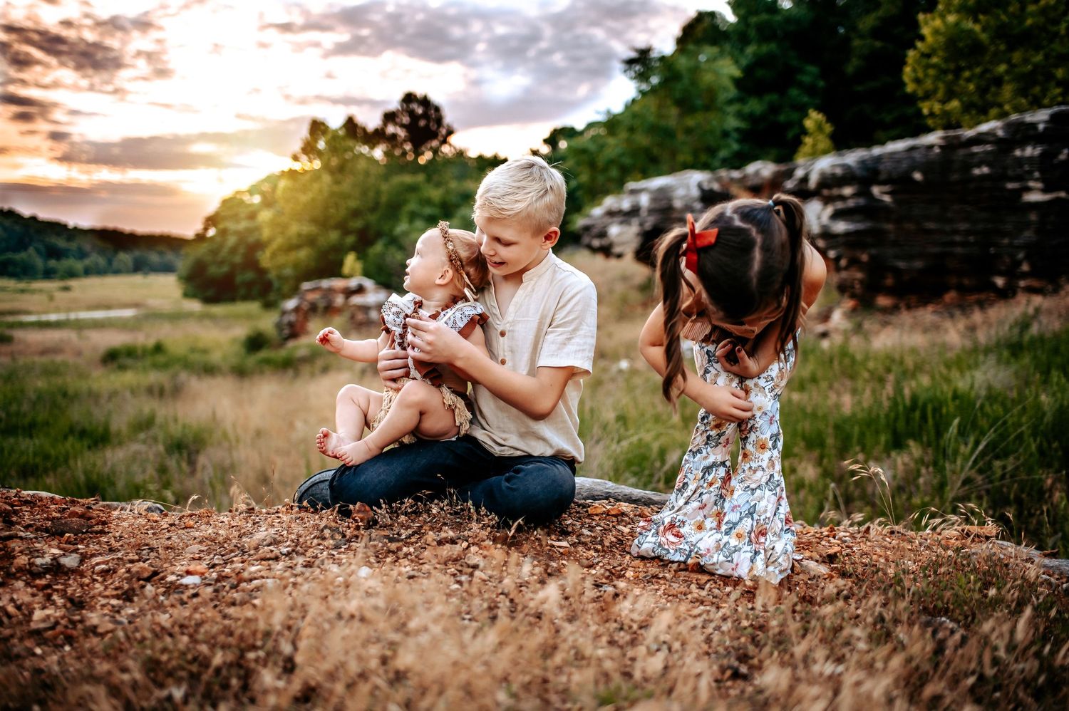 A tender moment captured during sunset on a rocky hillside with natural scenery.