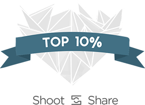 White geometric heart shape with blue banner reading 'TOP 10%' for Shoot and Share.