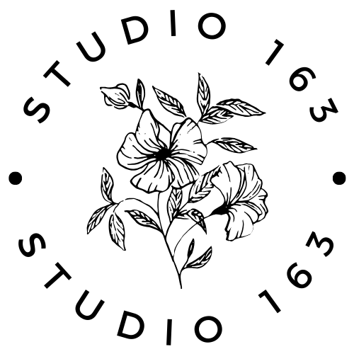 Minimalist black and white circular logo design featuring delicate hand-drawn hibiscus flowers and leaves.