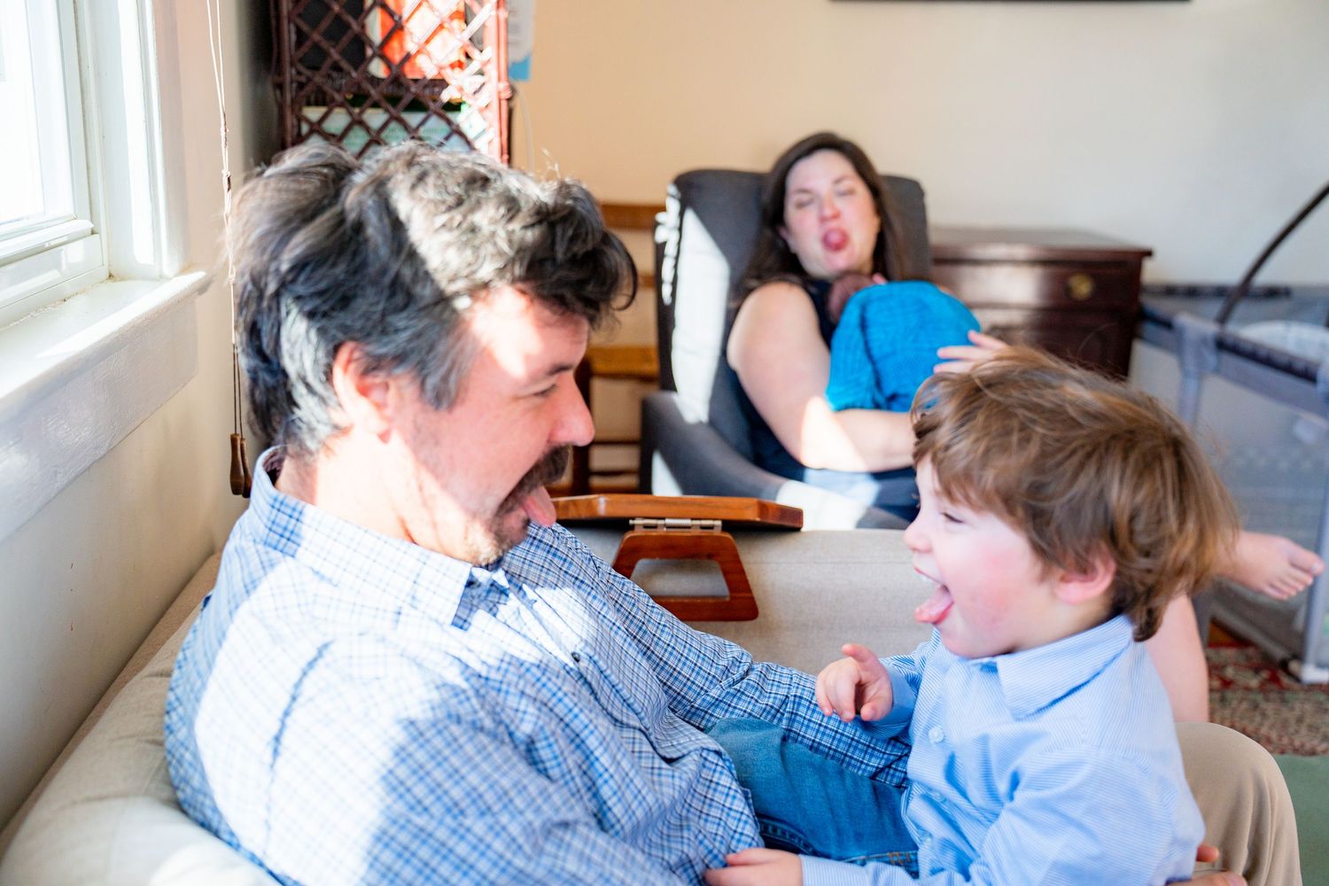 A series of tender moments between parent and child reading books together on a couch in a bright living room.