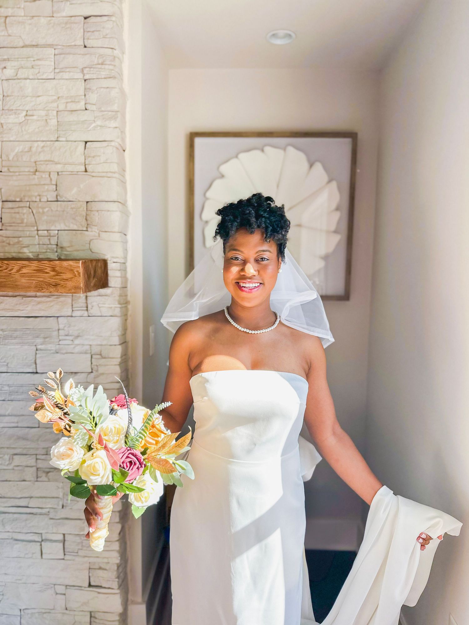 Elegant bridal portrait in a modern room with white stone walls.