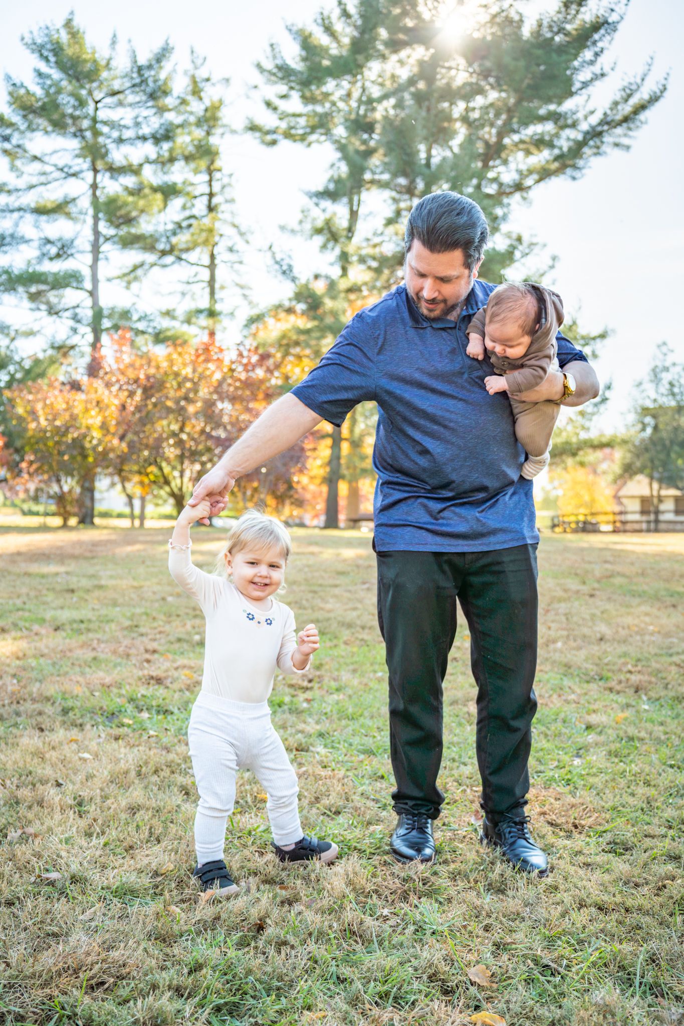 A series of candid outdoor shots showing a toddler learning to walk with assistance on a grassy field at sunset.