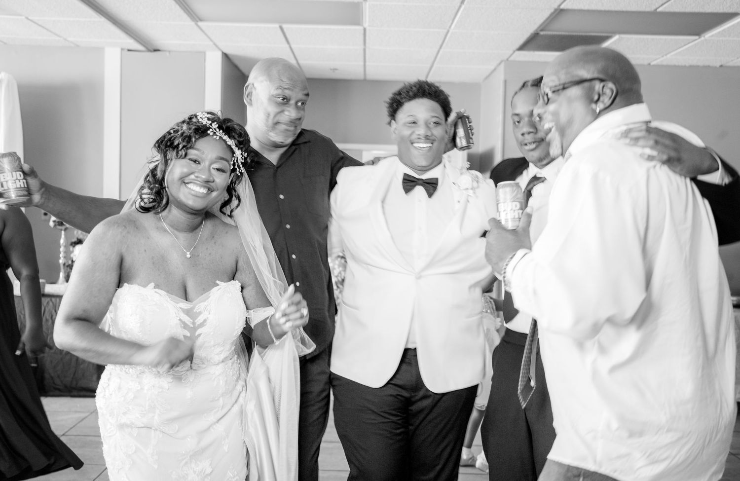 Black and white candid shots of wedding guests dancing and celebrating.