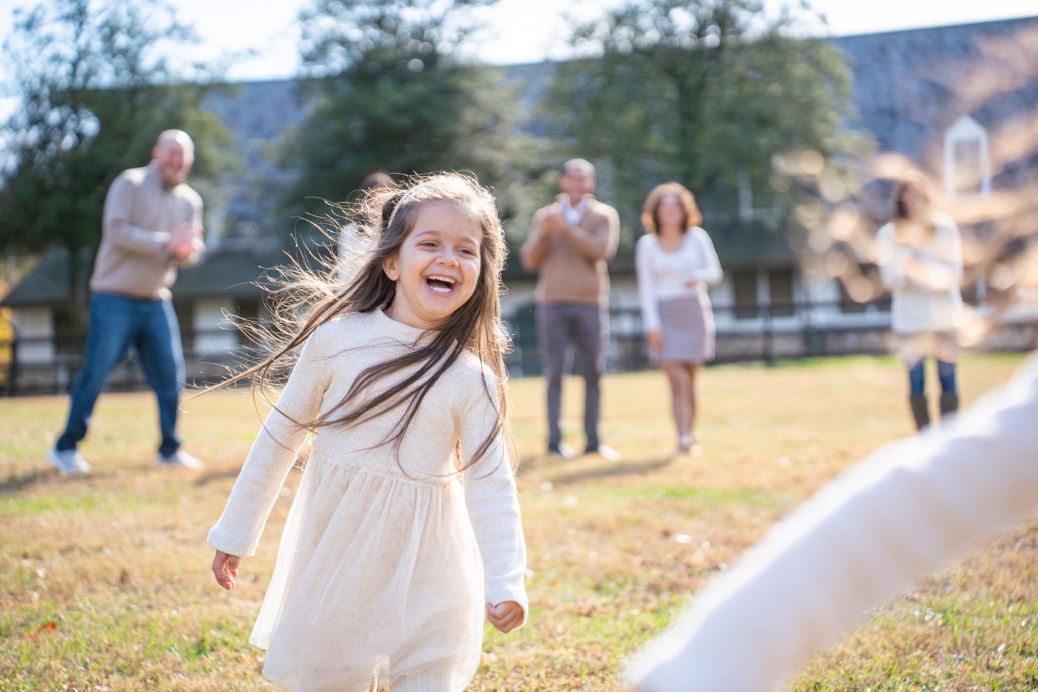 Multiple images of joyful moments captured outdoors with people wearing white and neutral colored clothing in sunlit settings.