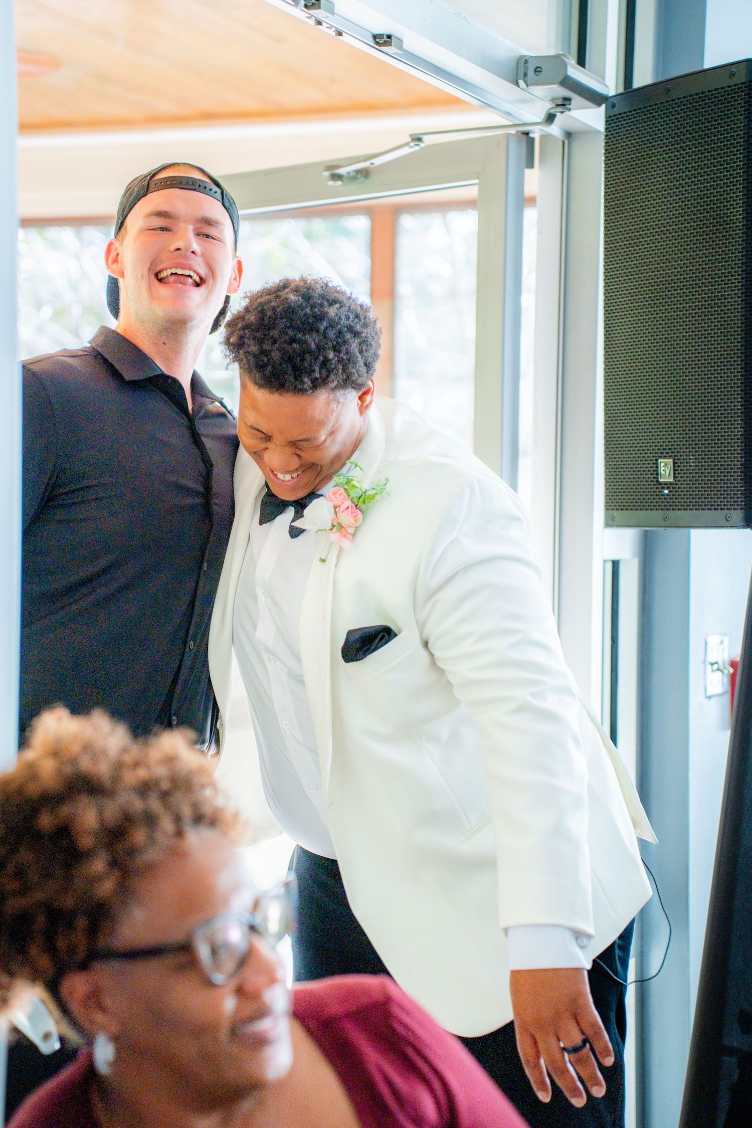 Wedding reception guests enjoying a lively celebration in formal attire.