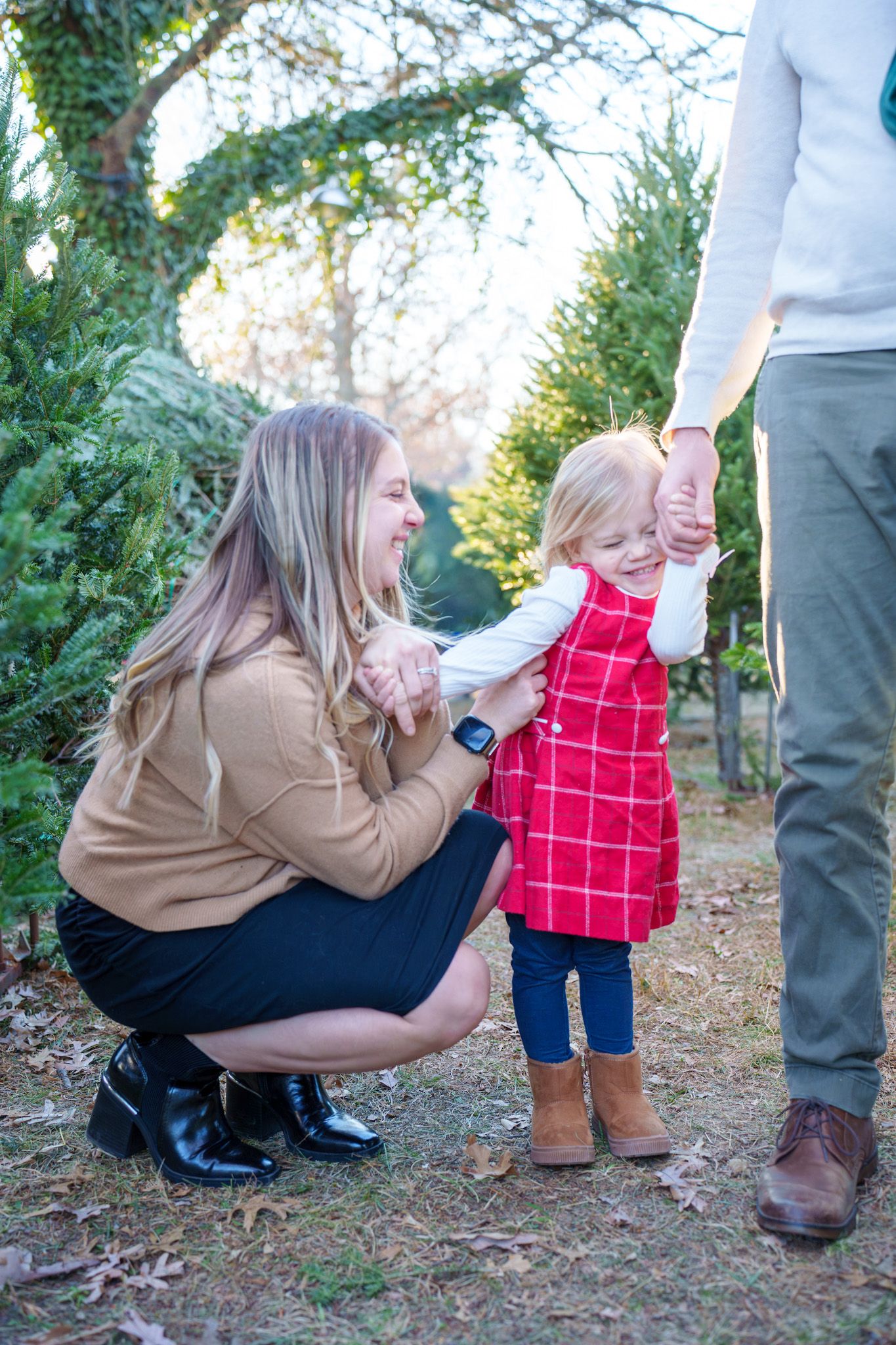 A sequence of candid outdoor moments showing interaction between people on a wooded path during autumn.