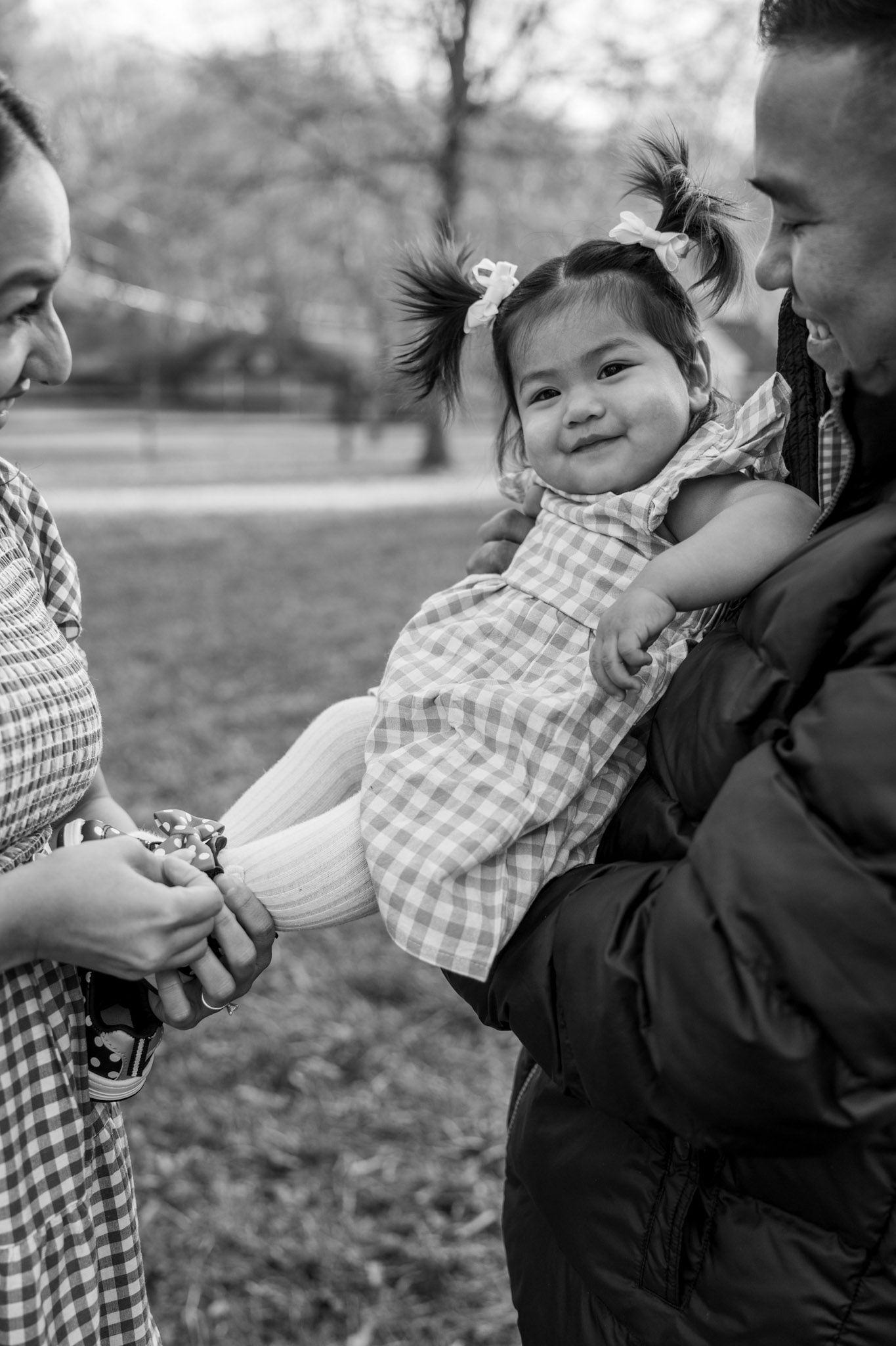 A sequence of black and white photos showing a playful interaction between a child in a checkered shirt and adult.