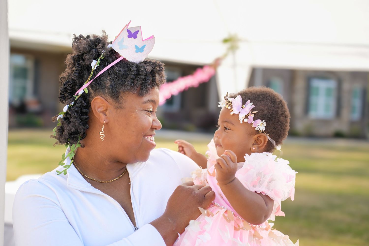 Outdoor celebration with pink tulle decorations and floral accessories.