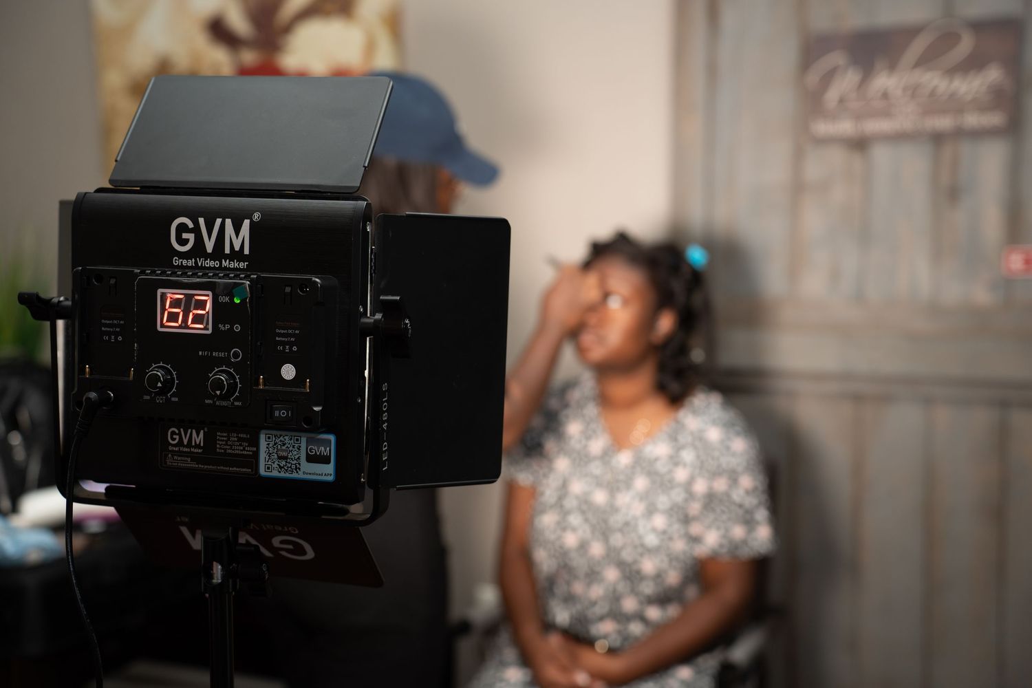 Professional video equipment and lighting setup in indoor venue.