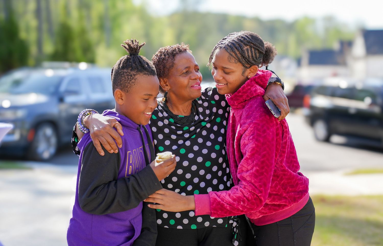 Students embrace and celebrate together outdoors in a series of candid moments showing friendship and joy.