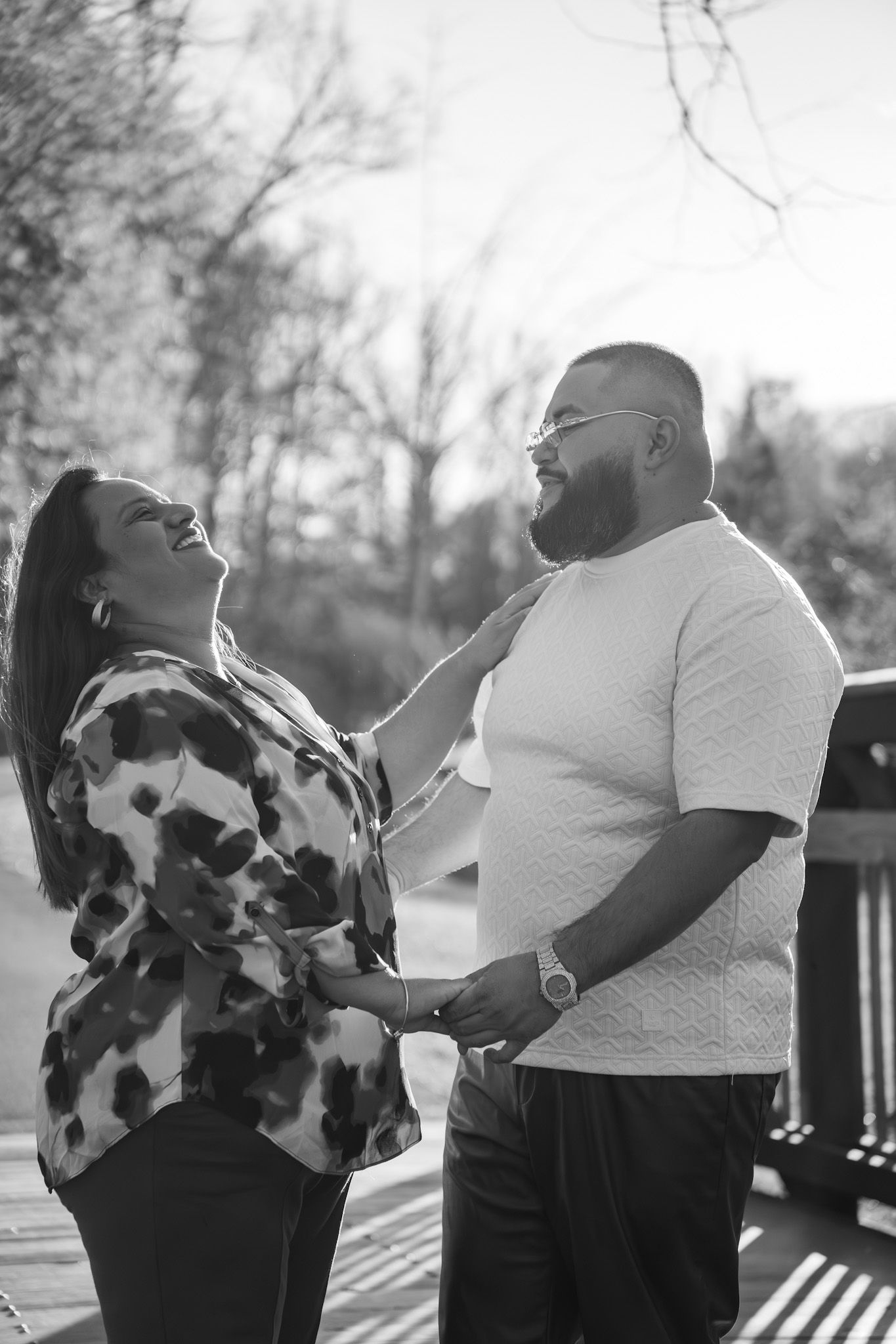 A couple shares intimate moments in a series of black and white photographs outdoors.