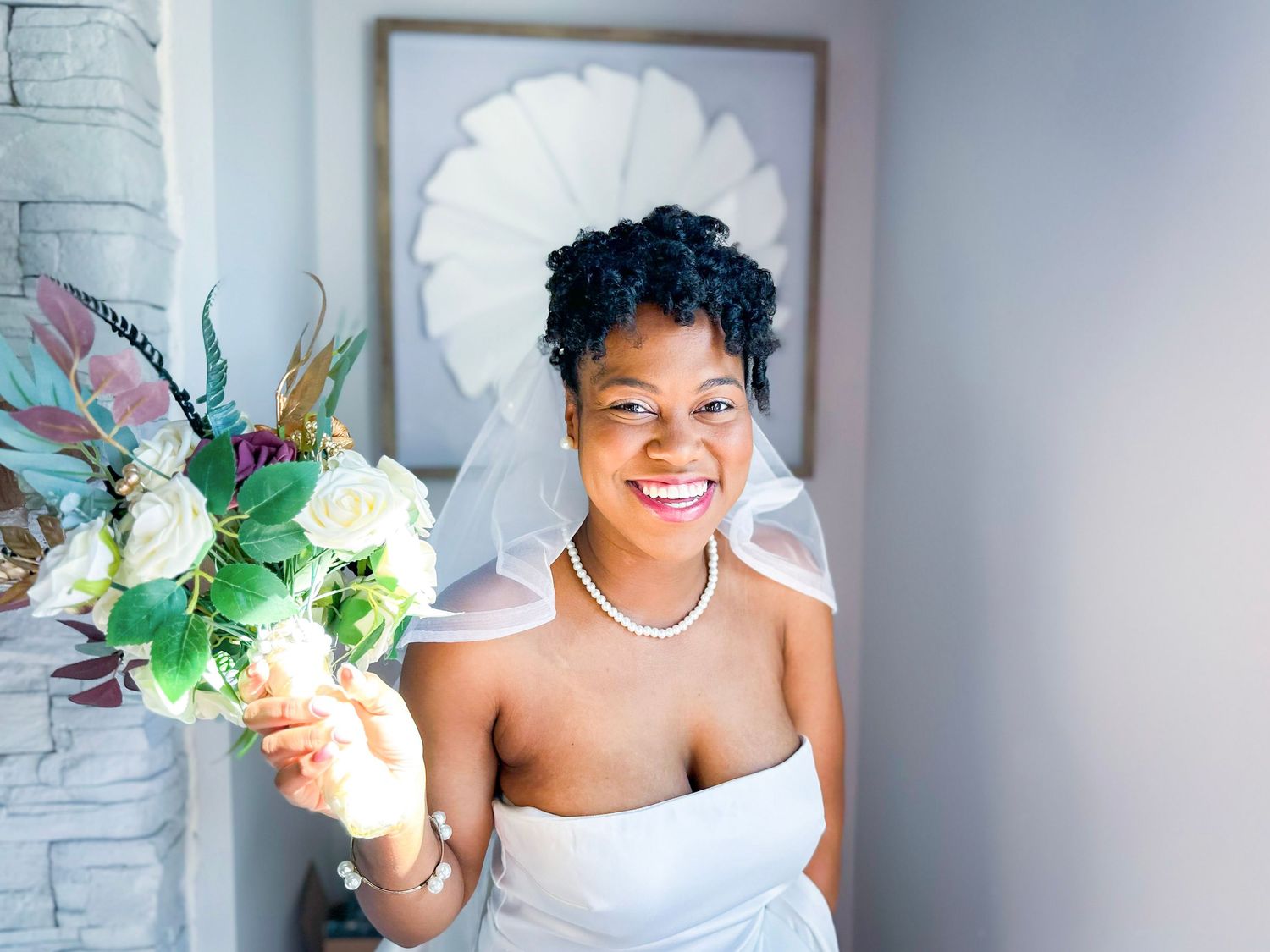Elegant bridal scene with white flowers and pearl necklace details.