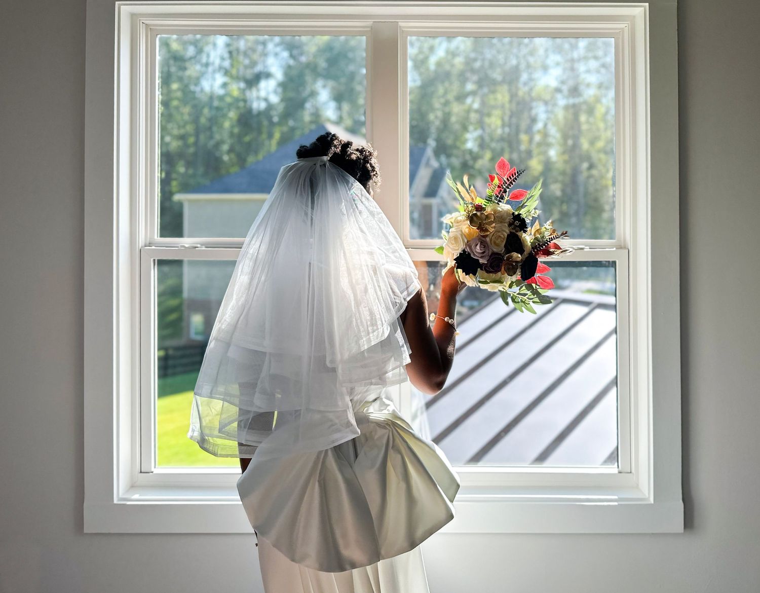 Wedding details with white roses and text document in black and white photography.