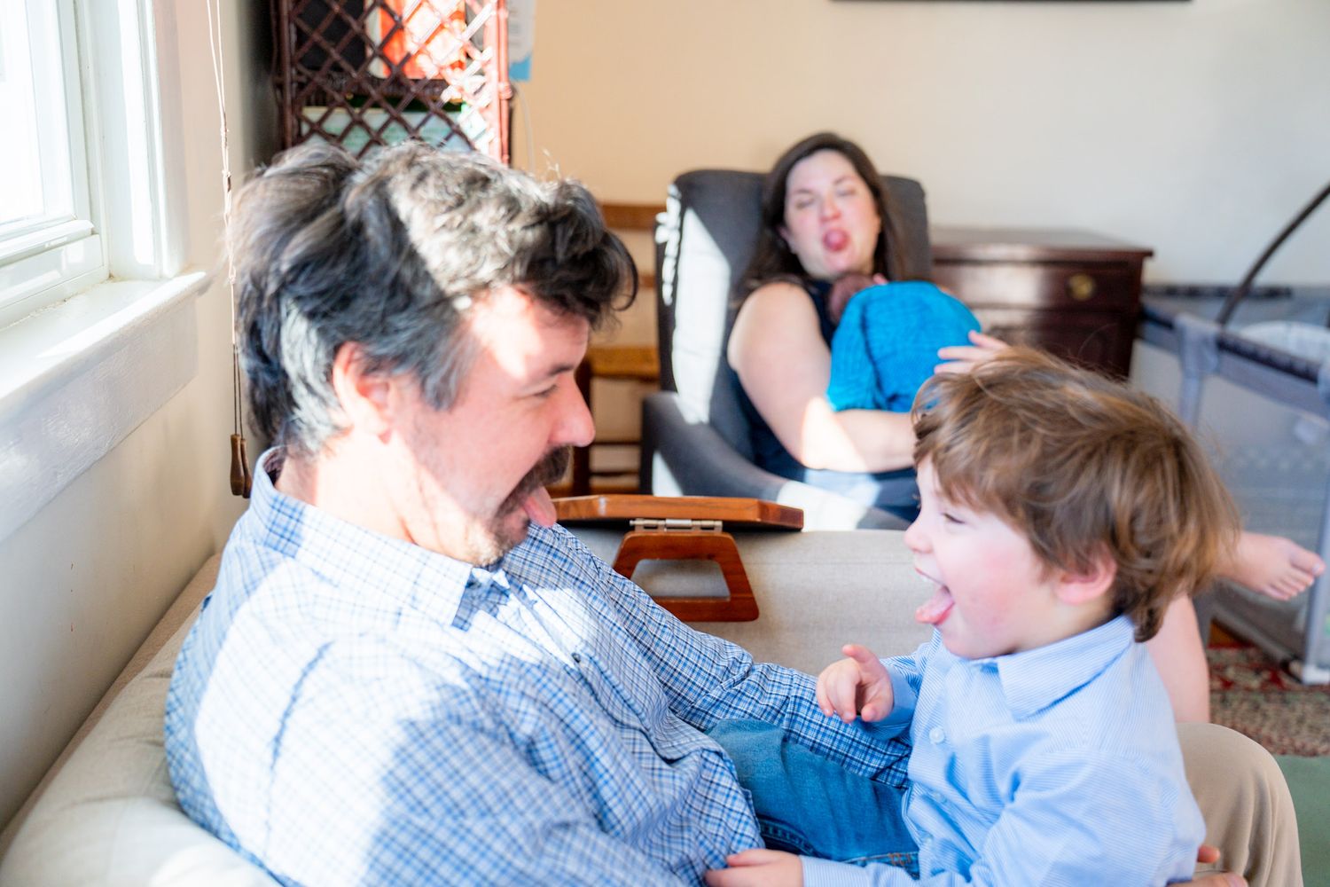 A series of tender moments between parent and child reading together on a couch in natural lighting.