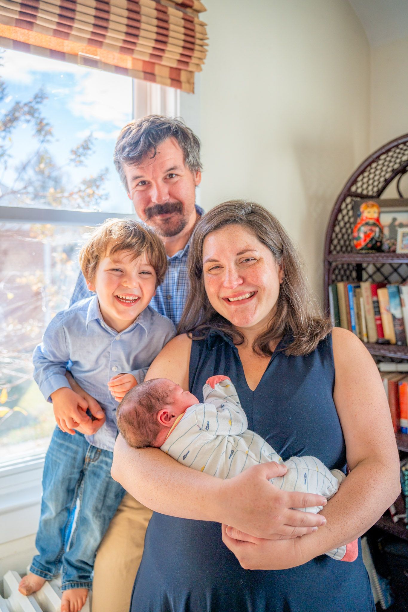 A series of four candid family photos showing tender moments with a baby in a sunlit room.