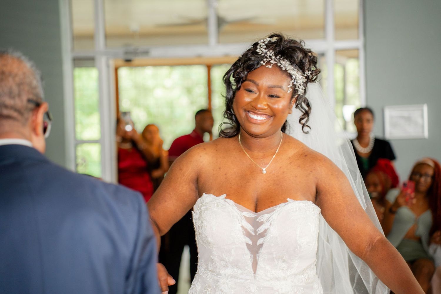 A joyful moment captured during a wedding reception as people dance and celebrate on the dance floor.