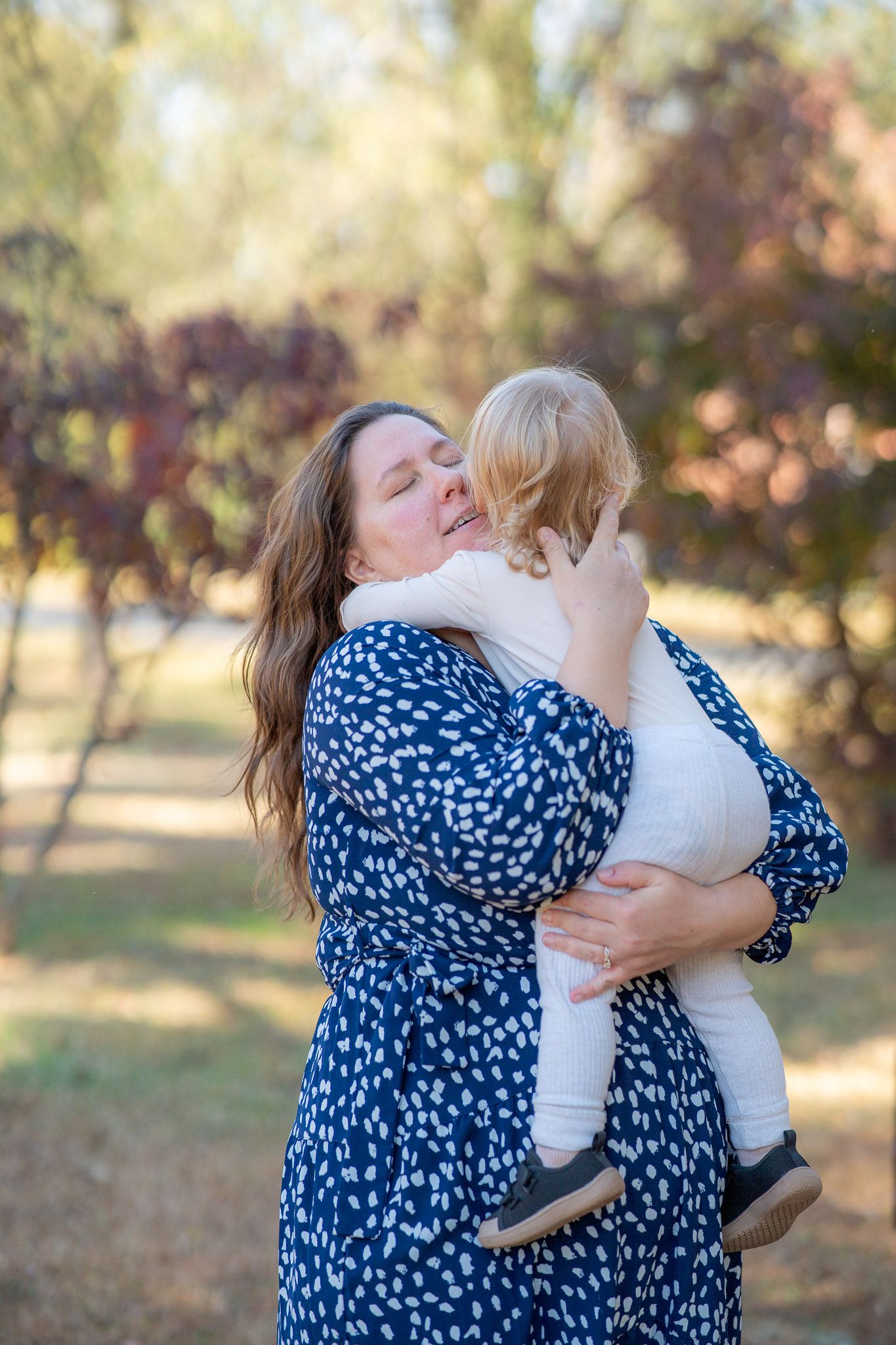 A series of five candid photos showing tender embraces between two people in a sunny outdoor setting.