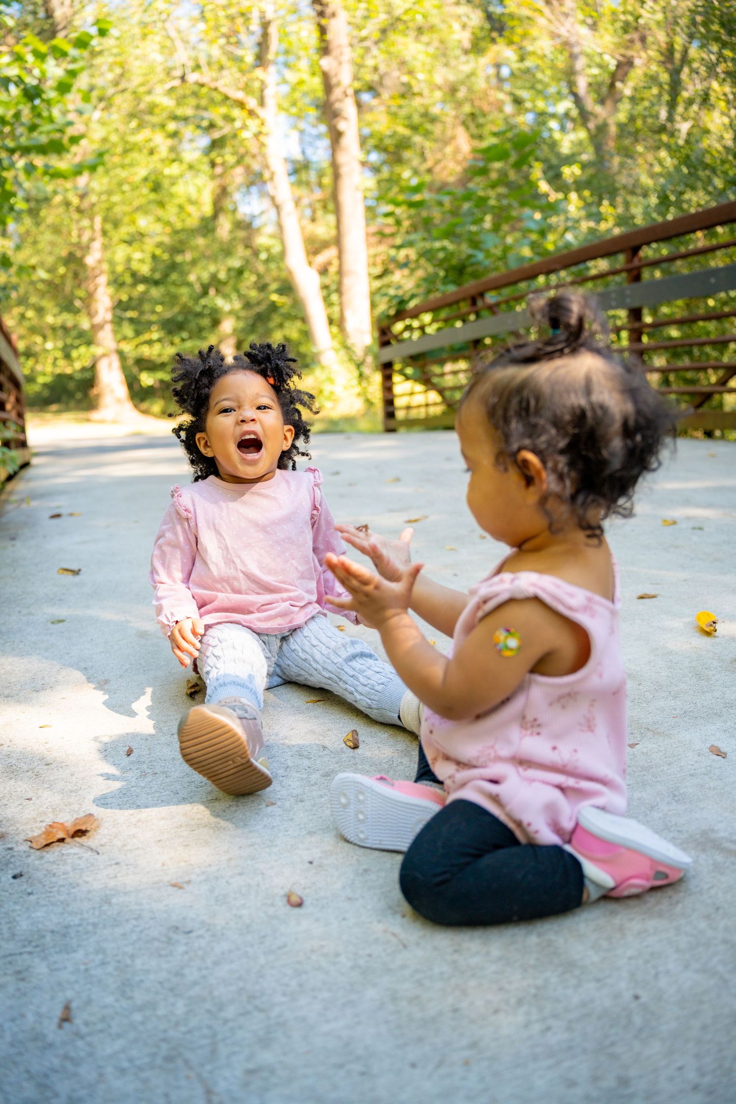 A sequence of joyful moments captured on a concrete surface with fallen autumn leaves in natural sunlight.
