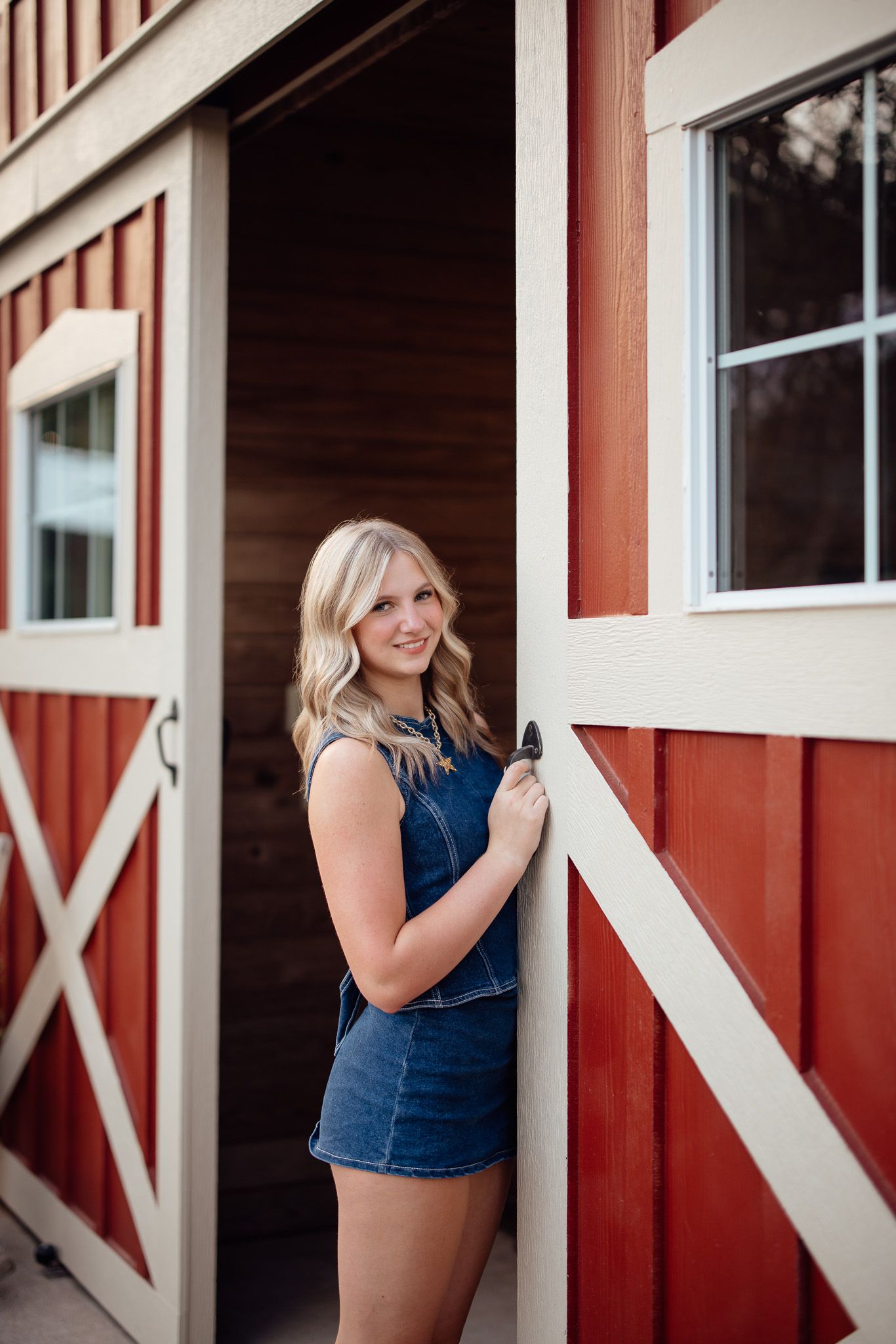 A series of photos showing a red barn with white trim and windows in a rustic country setting.