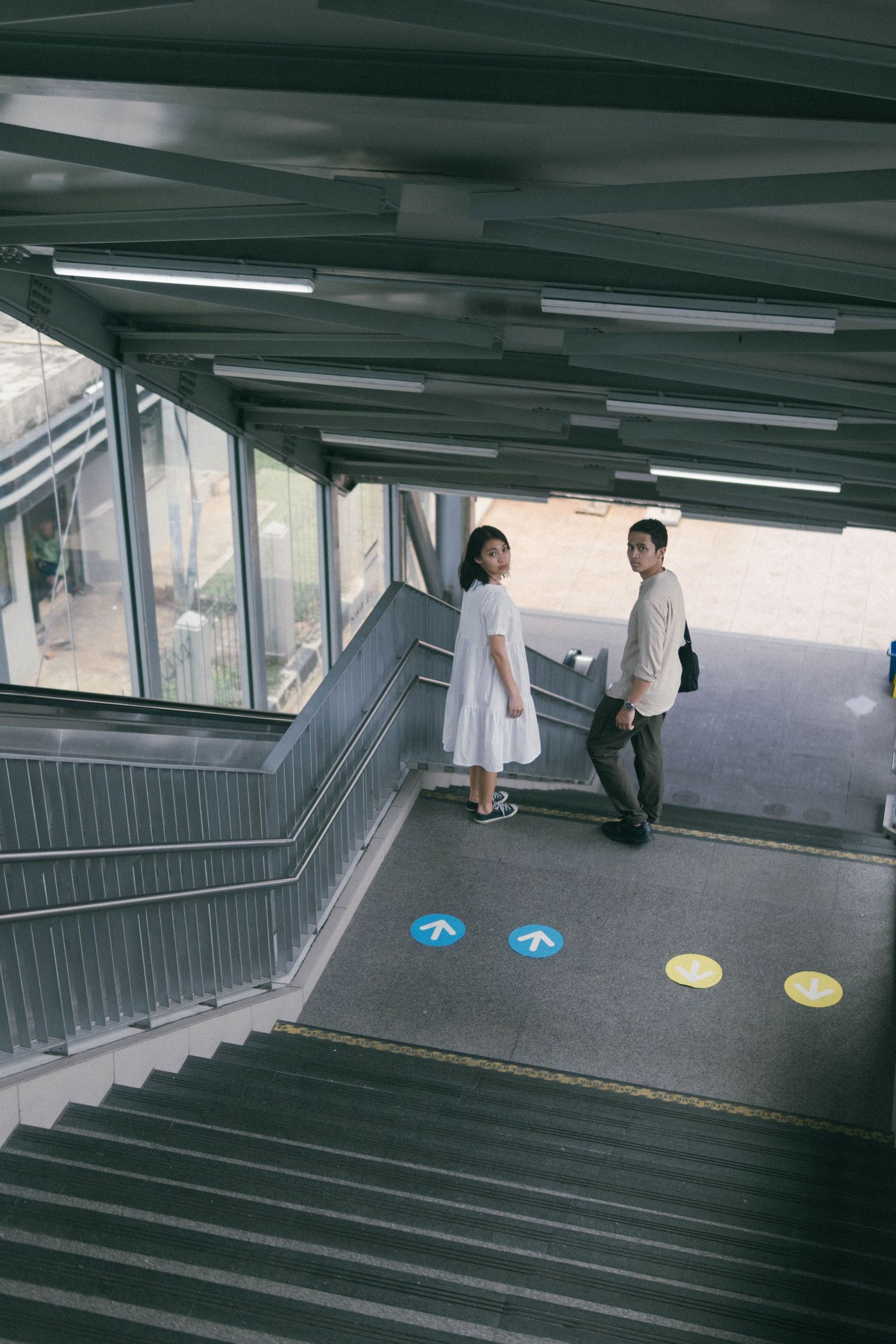 MRT Blok M jakarta prewedding photoshoot, couple standing on MRT stairs