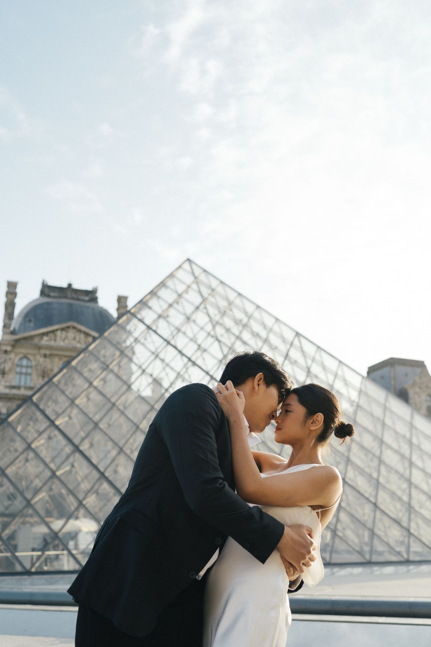 Romantic pre-wedding shoot Indonesian couple at the louvre pyramid