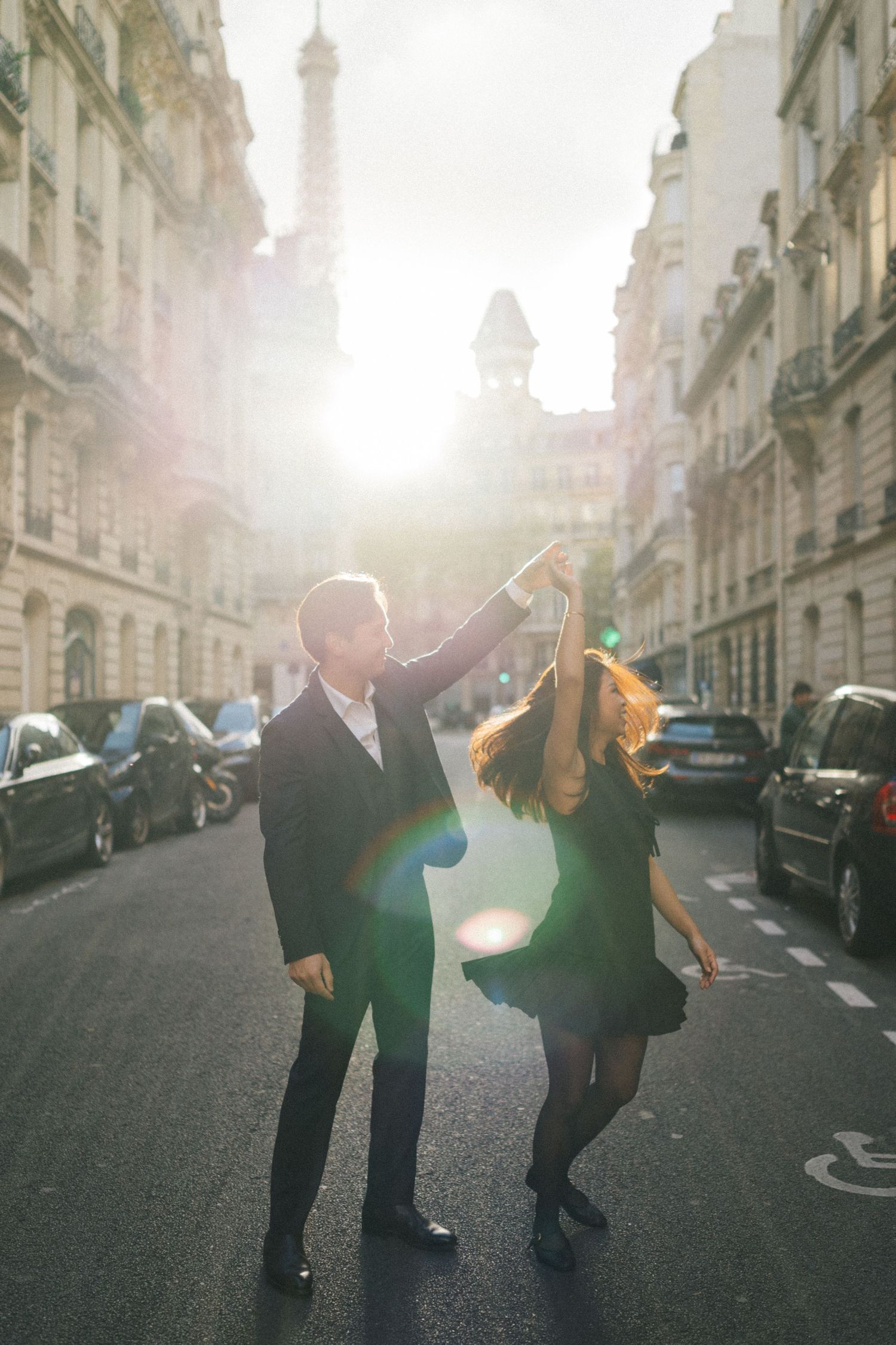 Engagement photoshoot at avenue rapp eith eiffel tower in the background, the couple is dancing